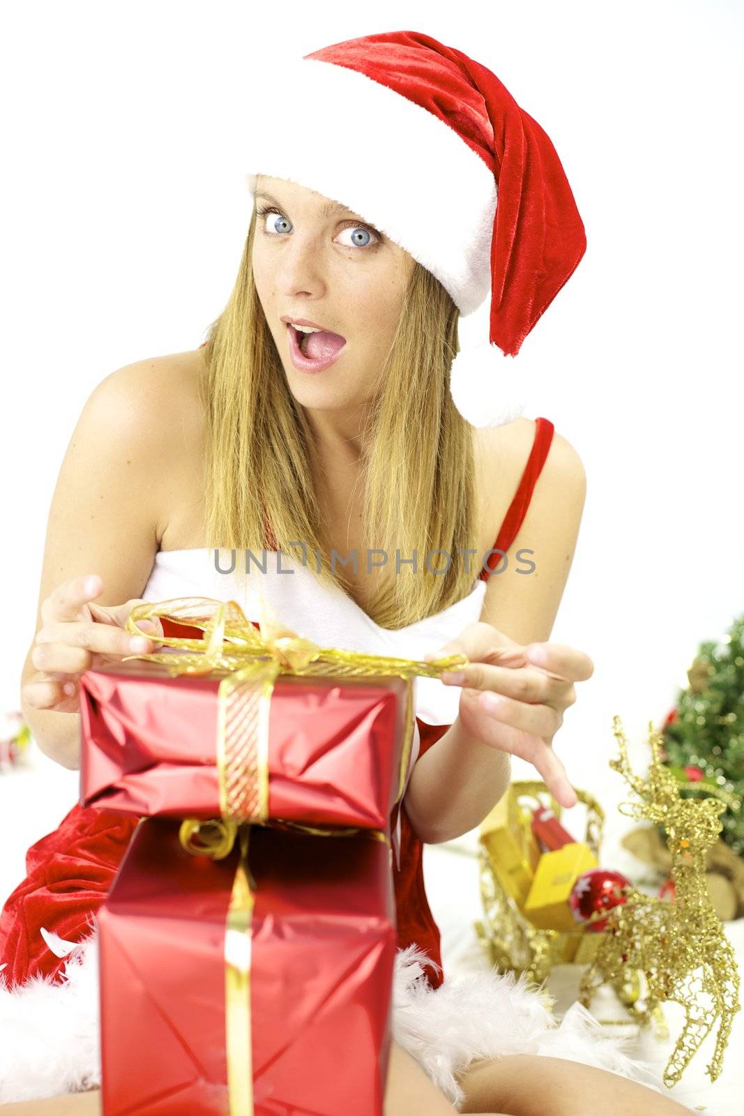 Smiling Santa Claus finishing to prepare packages gifts for Christmas night