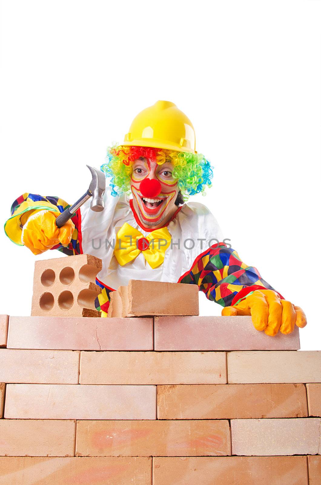 Bad construction concept with clown laying bricks by Elnur