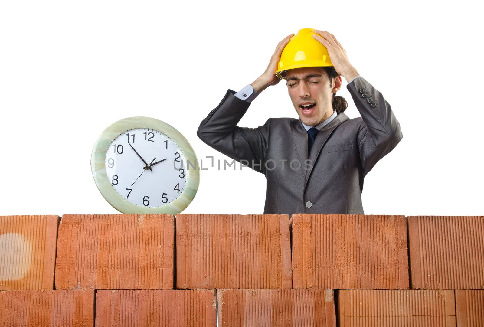 Businessman with bricks on white