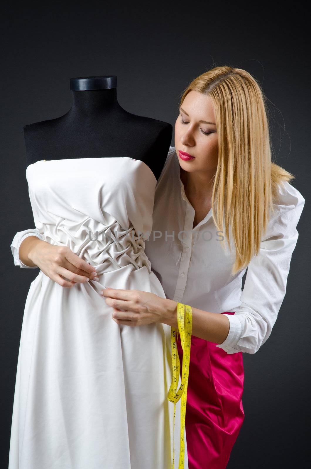 Woman tailor working on dress 