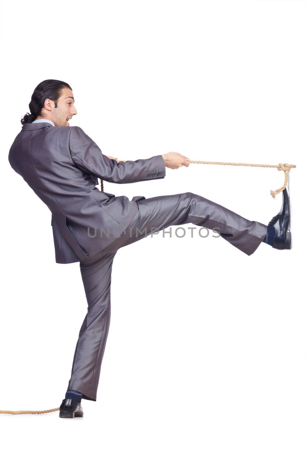 Businessman pulling rope on white by Elnur