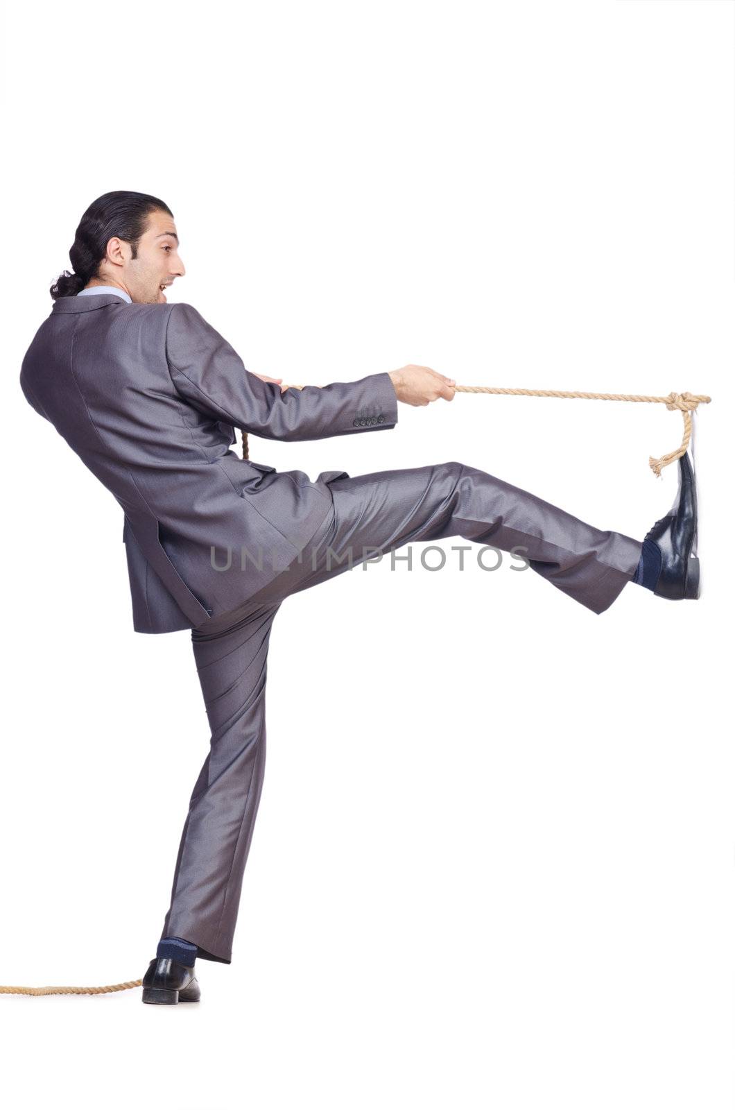 Businessman pulling rope on white