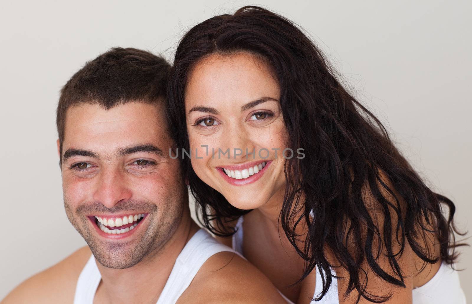 Young smiling romantic couple relaxing on the bed