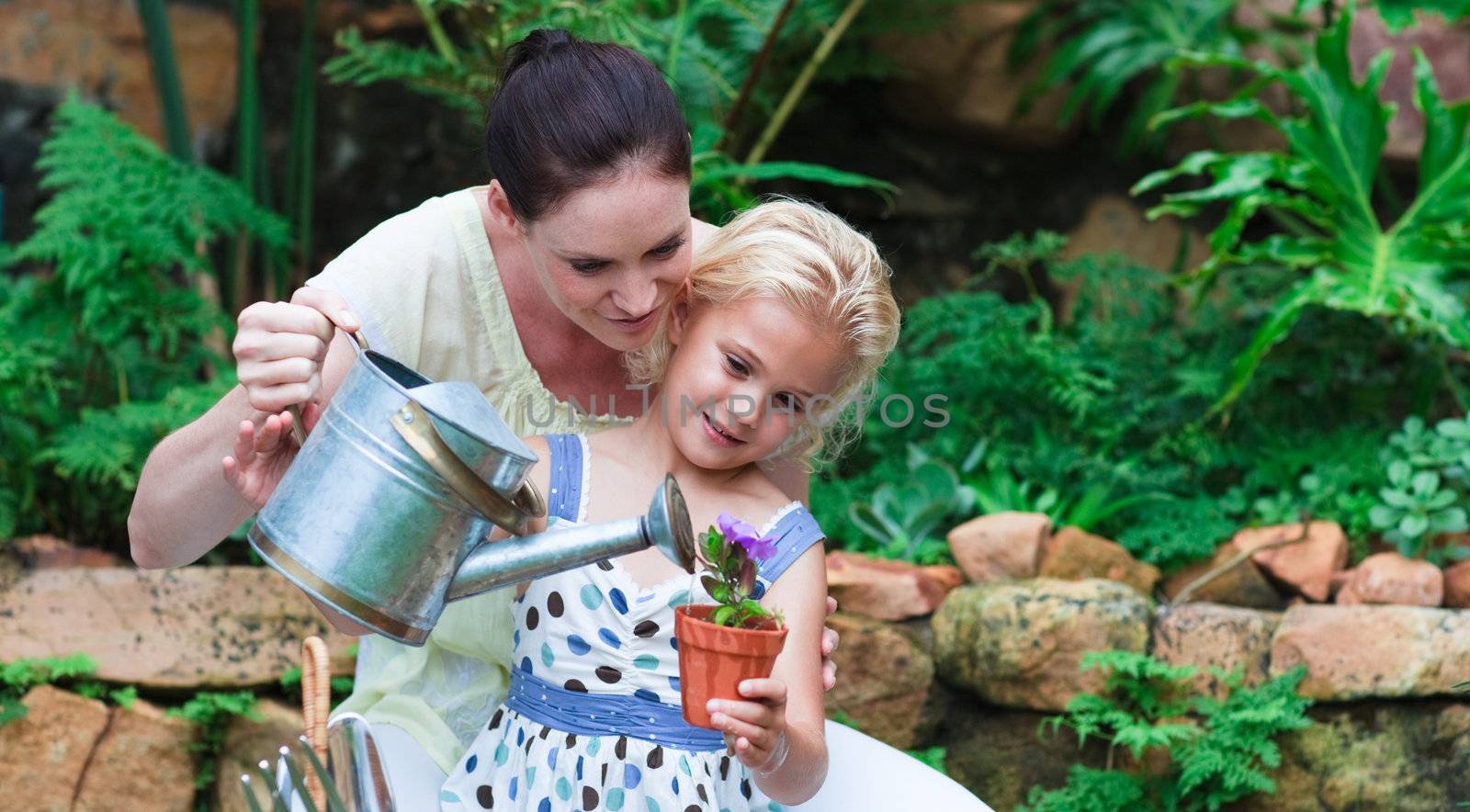  Young family with flowers in the garden