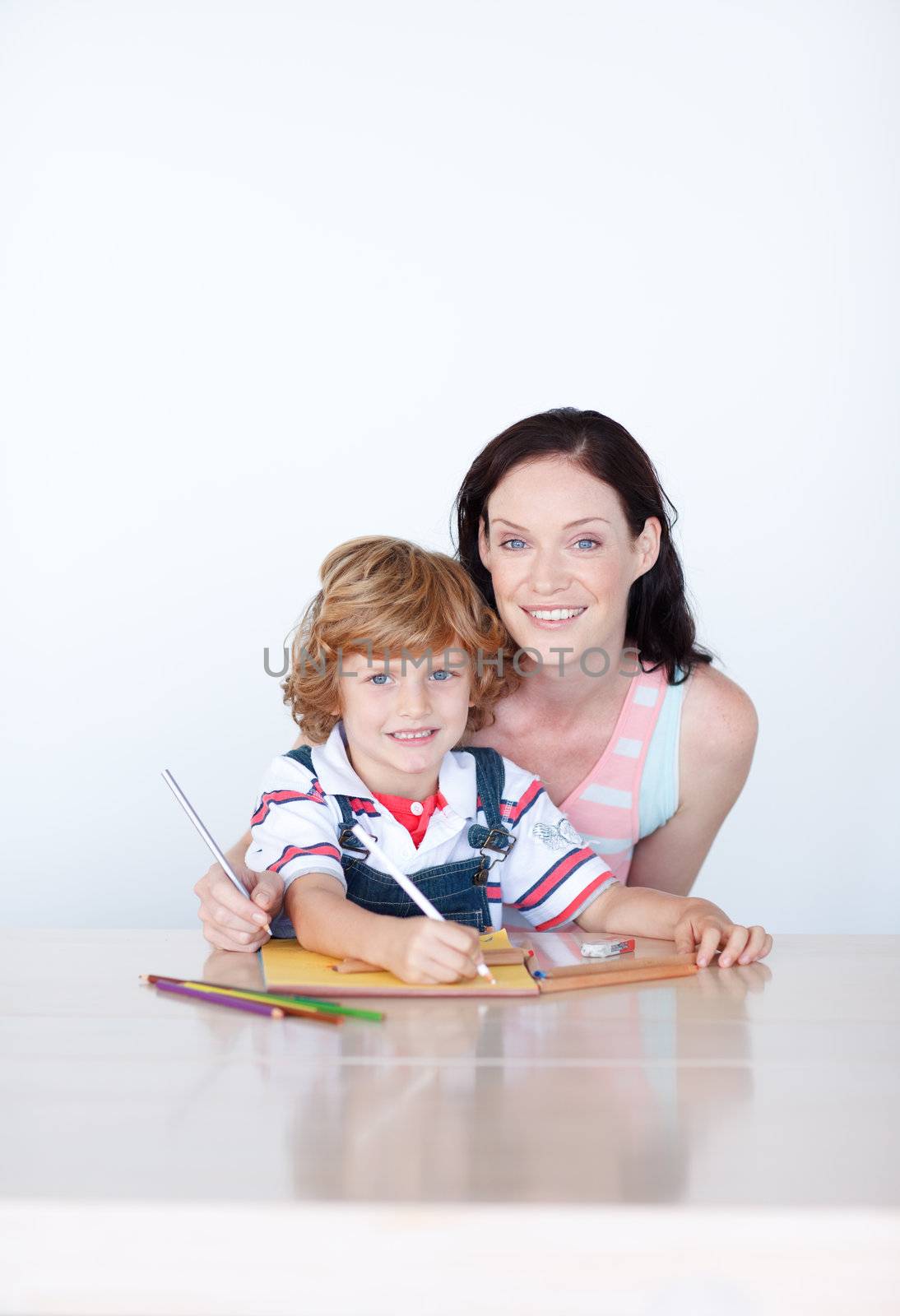 Mother and son drawing with copyspace looking at the camera