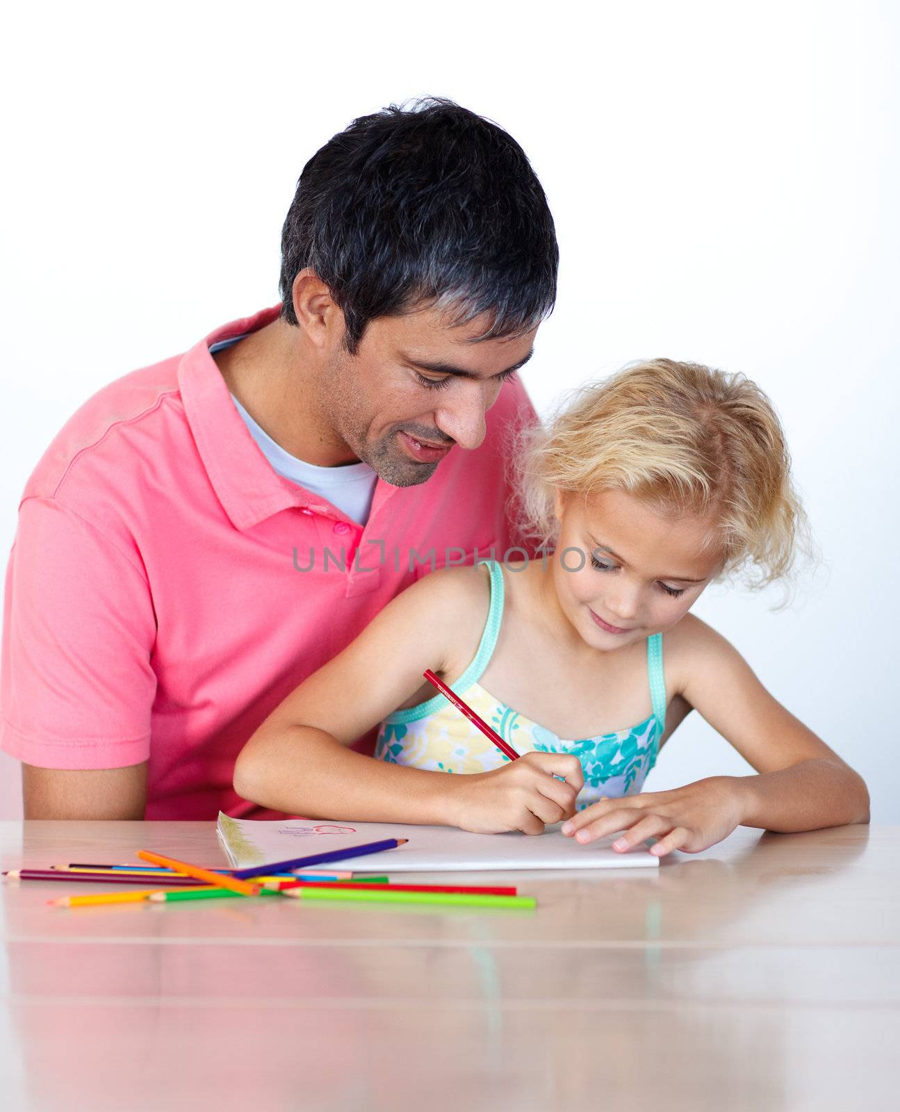 Beautiful daughter painting with her father at home 