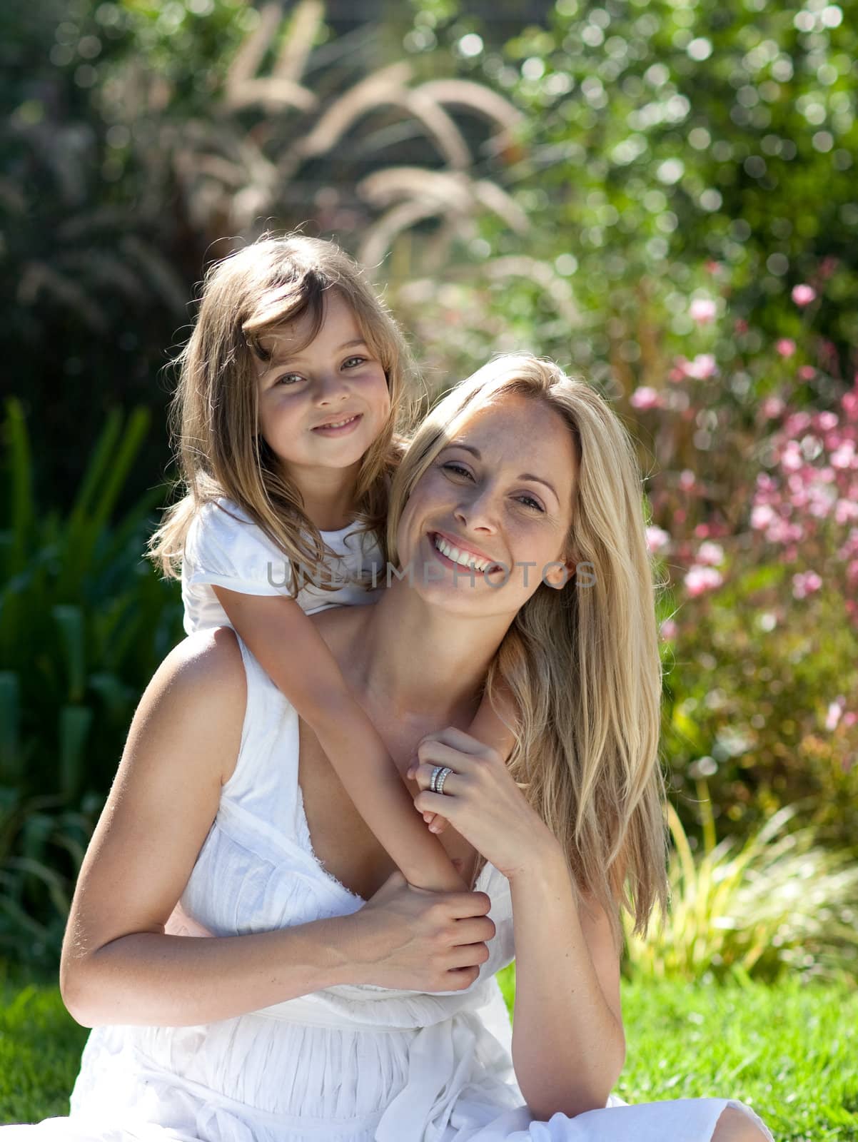 Beautiful mother and daughter outdoors in the sunshine by Wavebreakmedia