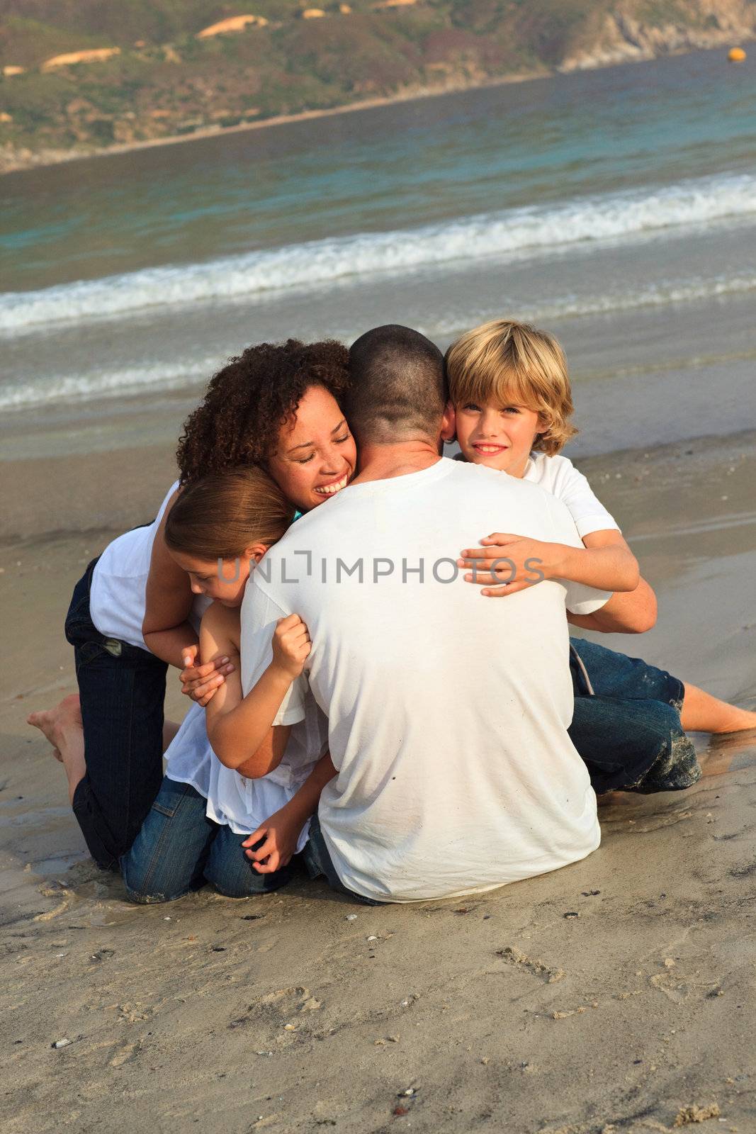 Joyful Family on the beach having fun  by Wavebreakmedia