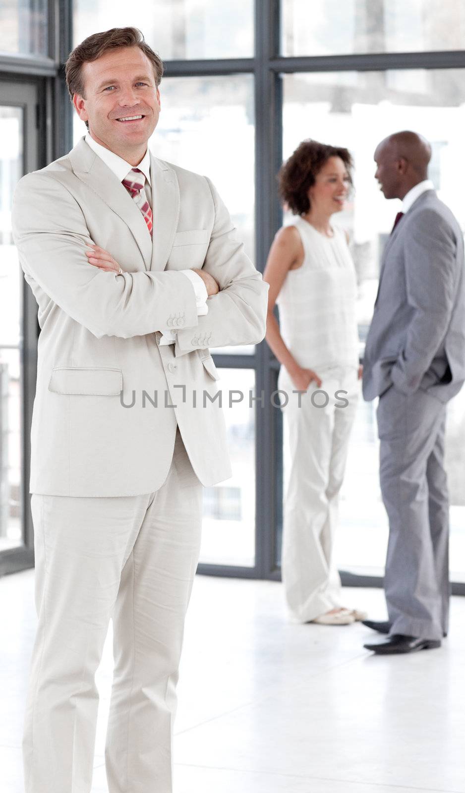 portrait of a caucasian male manager leading his team in a office