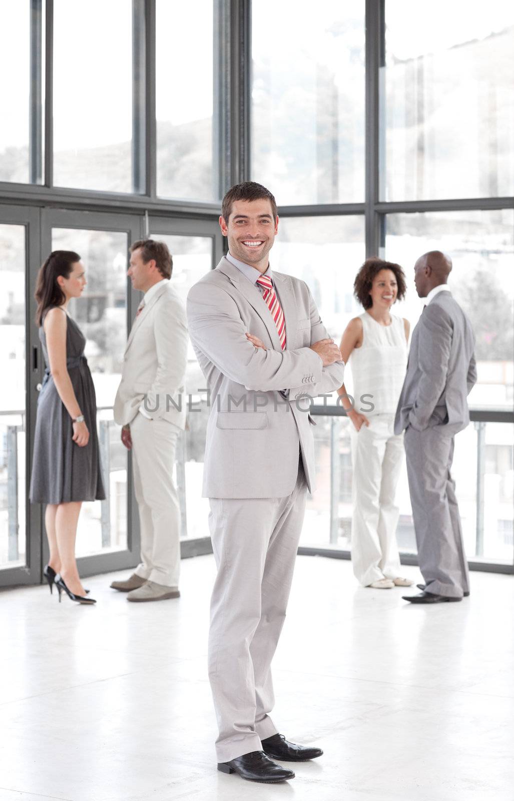 portrait of a joyful manager leading his team in a office
