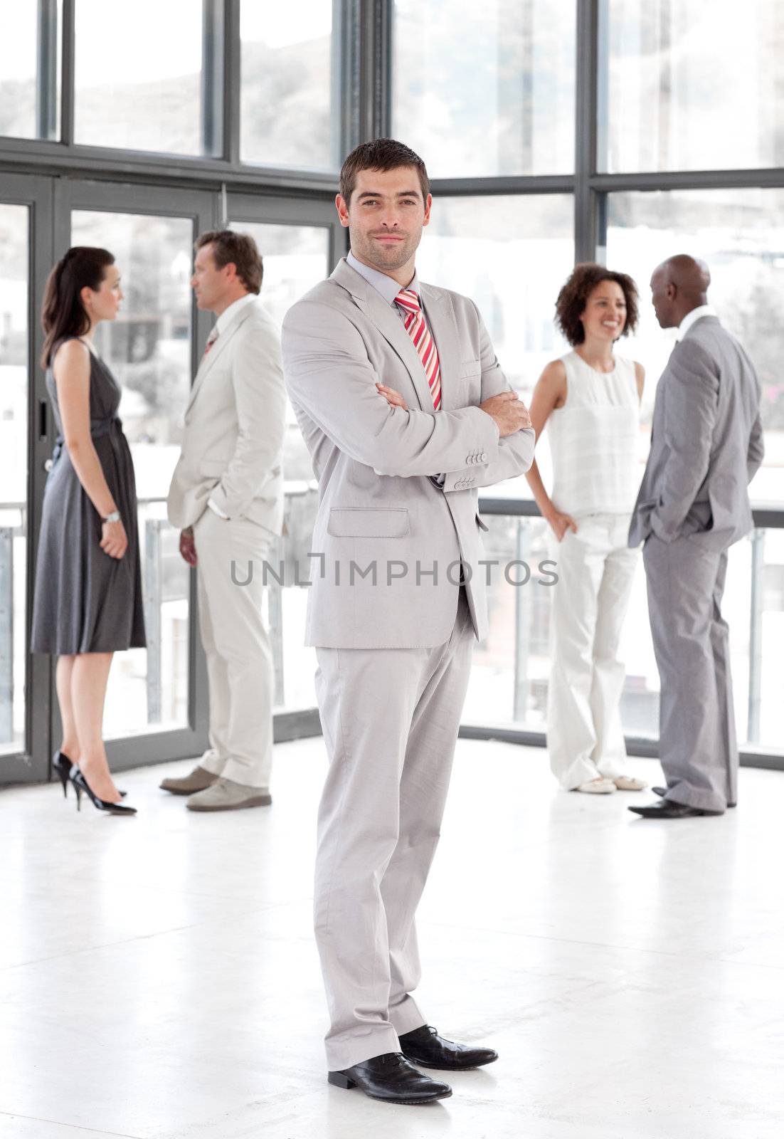 portrait of a latin manager leading his team in a office