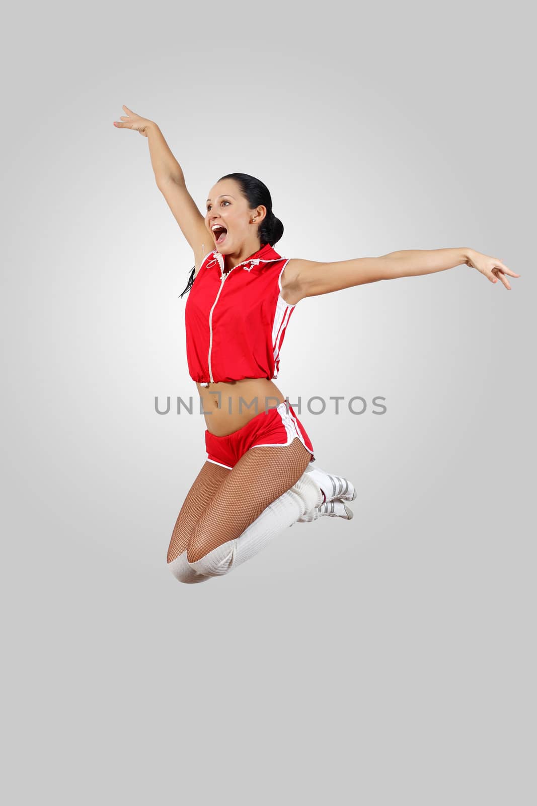 Young female dancer jumping against white background