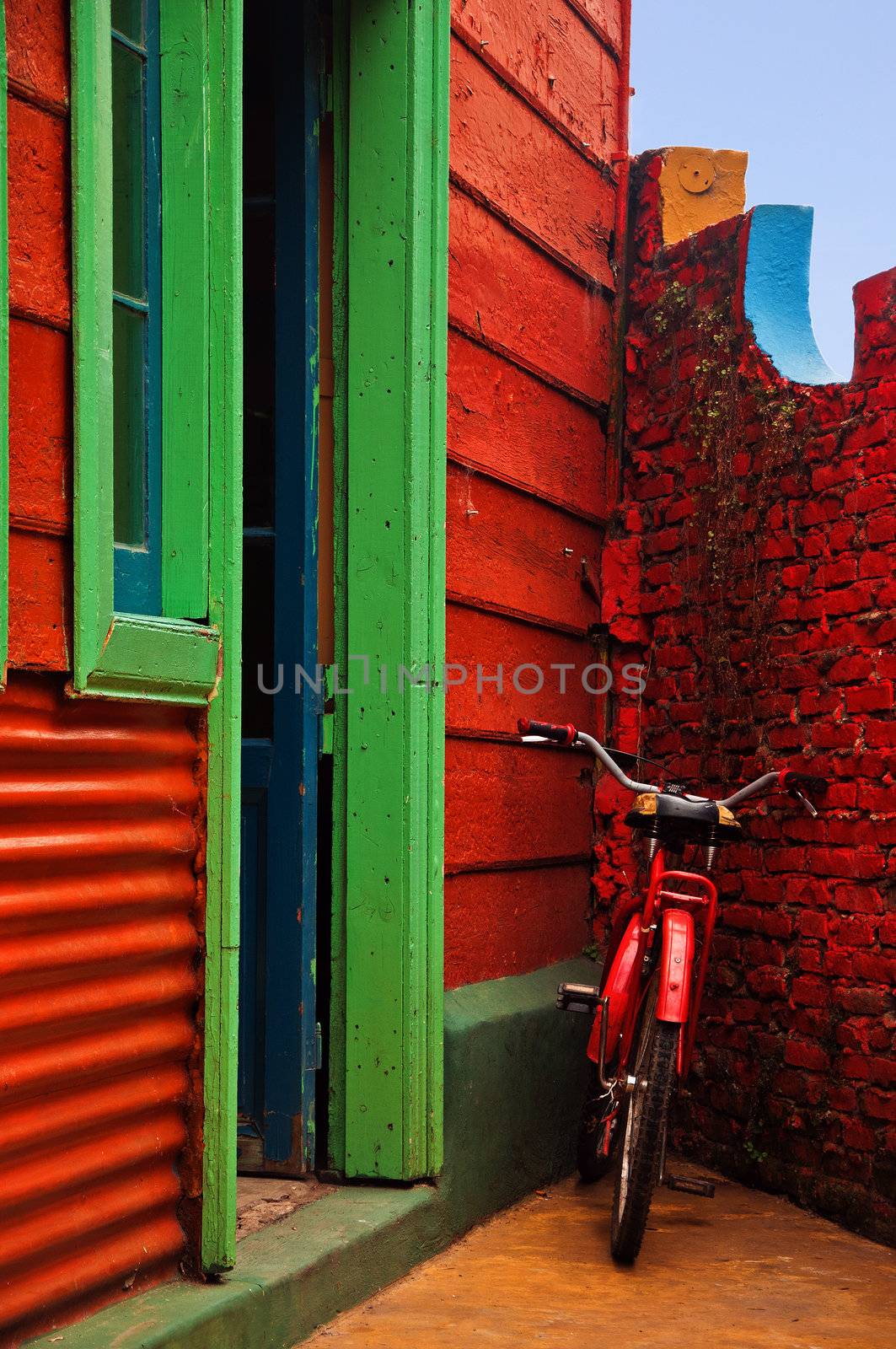 Red Bicycle next to a Red Wall by jkraft5