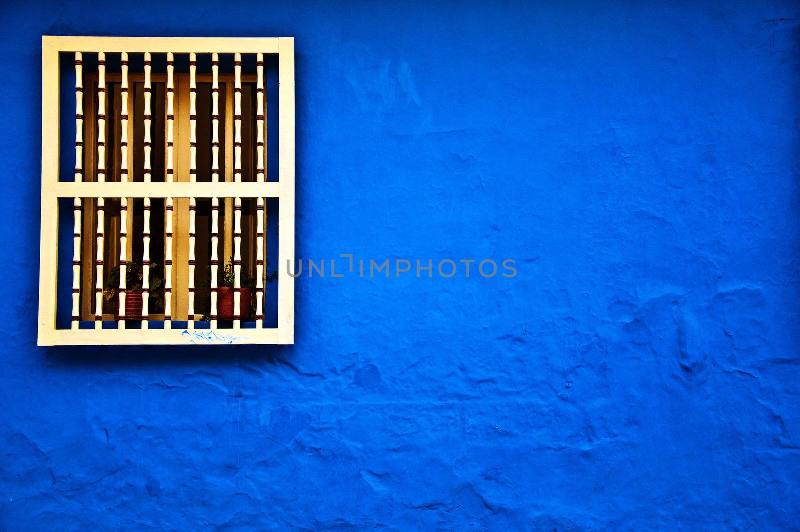 A colonial styled window and wall in the historical center of Bogota, Colombia.