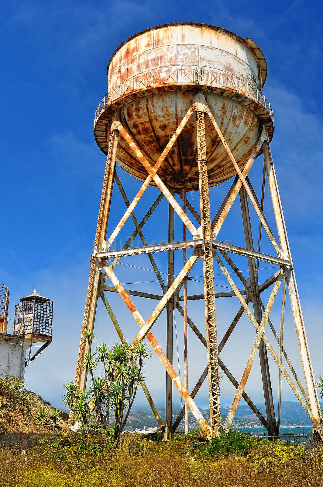 Rusty old water tank tower by martinm303