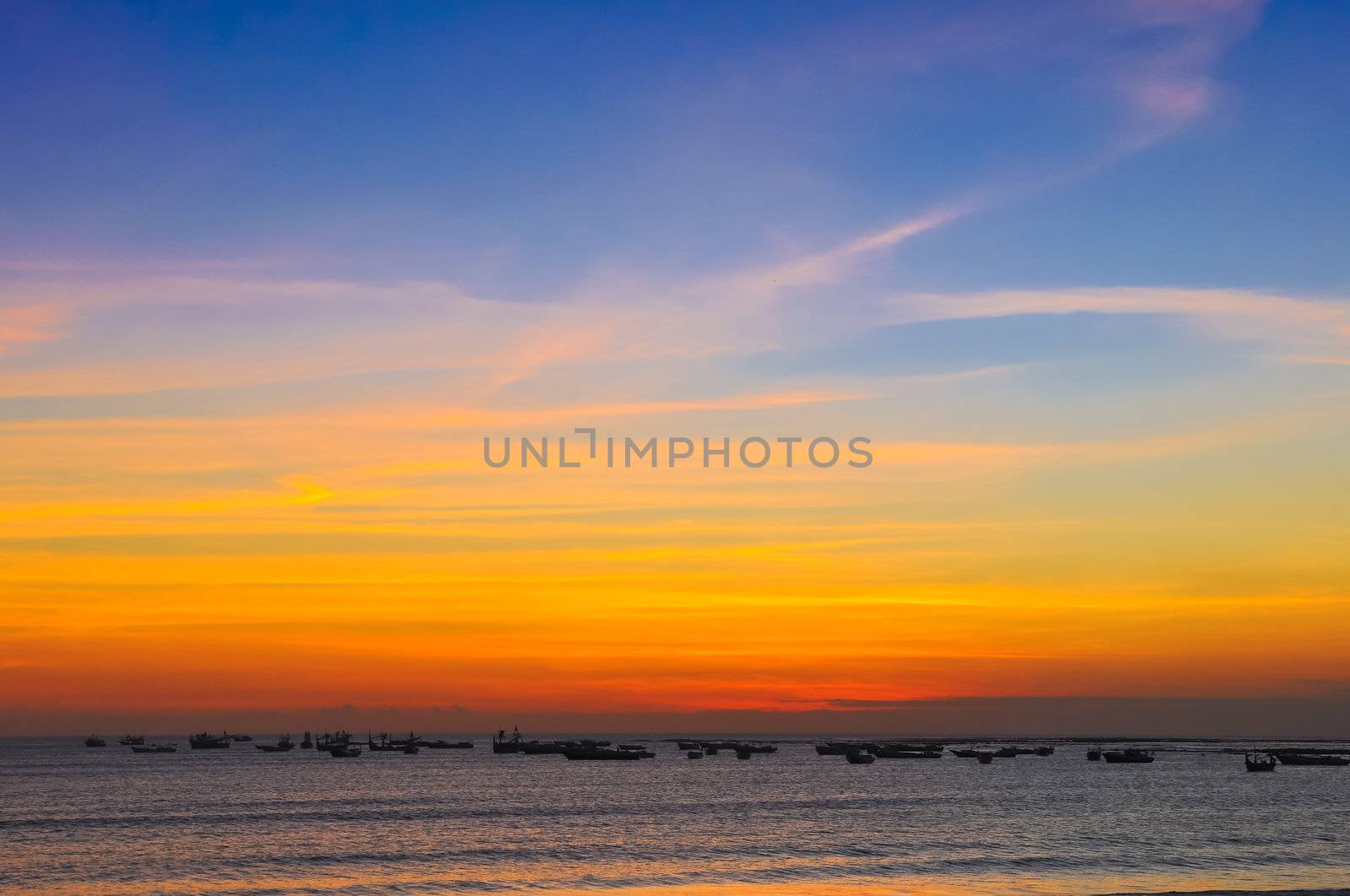 Ocean coast sunset and fishing boats, Bali, Indonesia