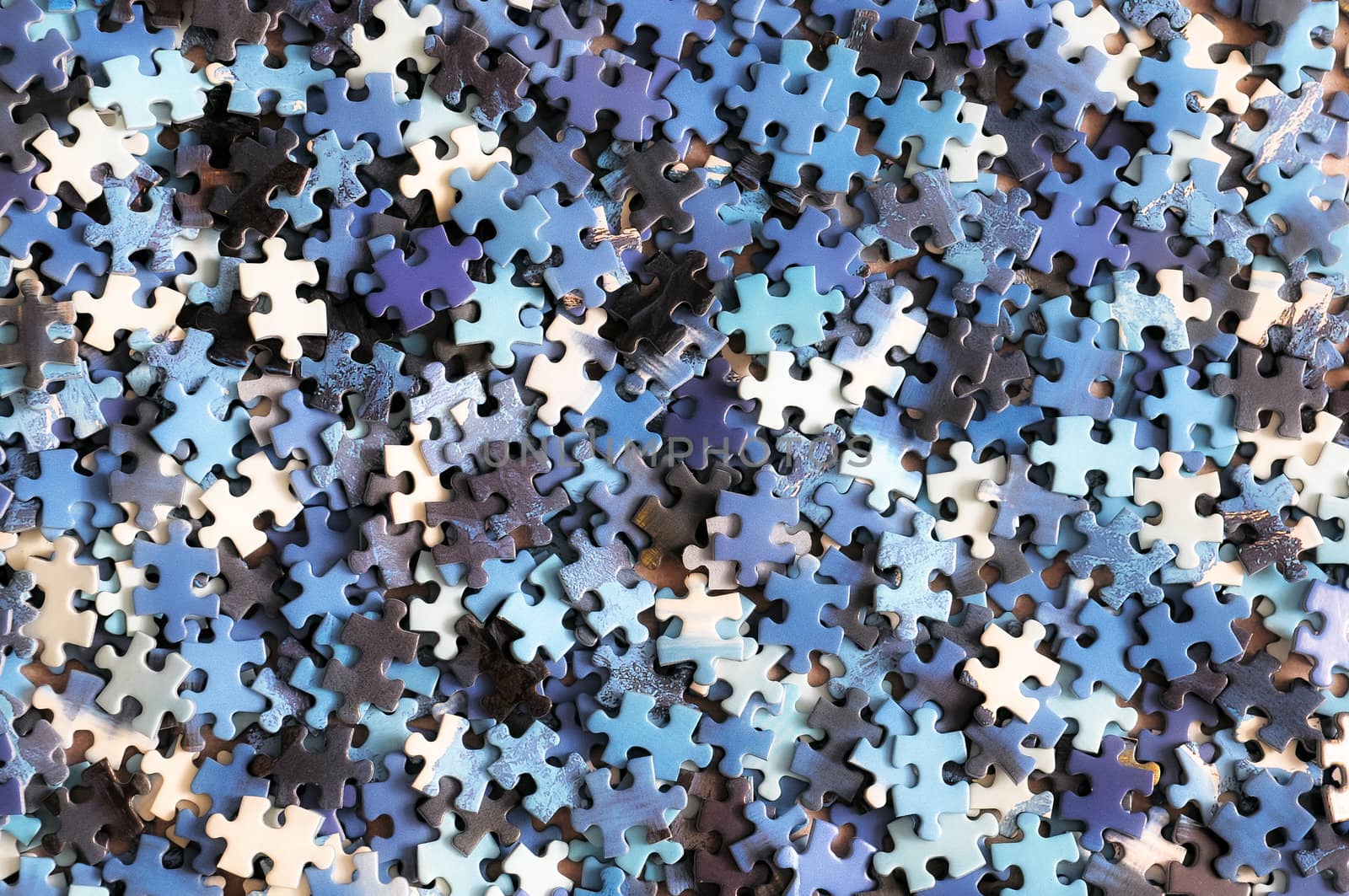 Unfinished colorful puzzle pieces close up by martinm303