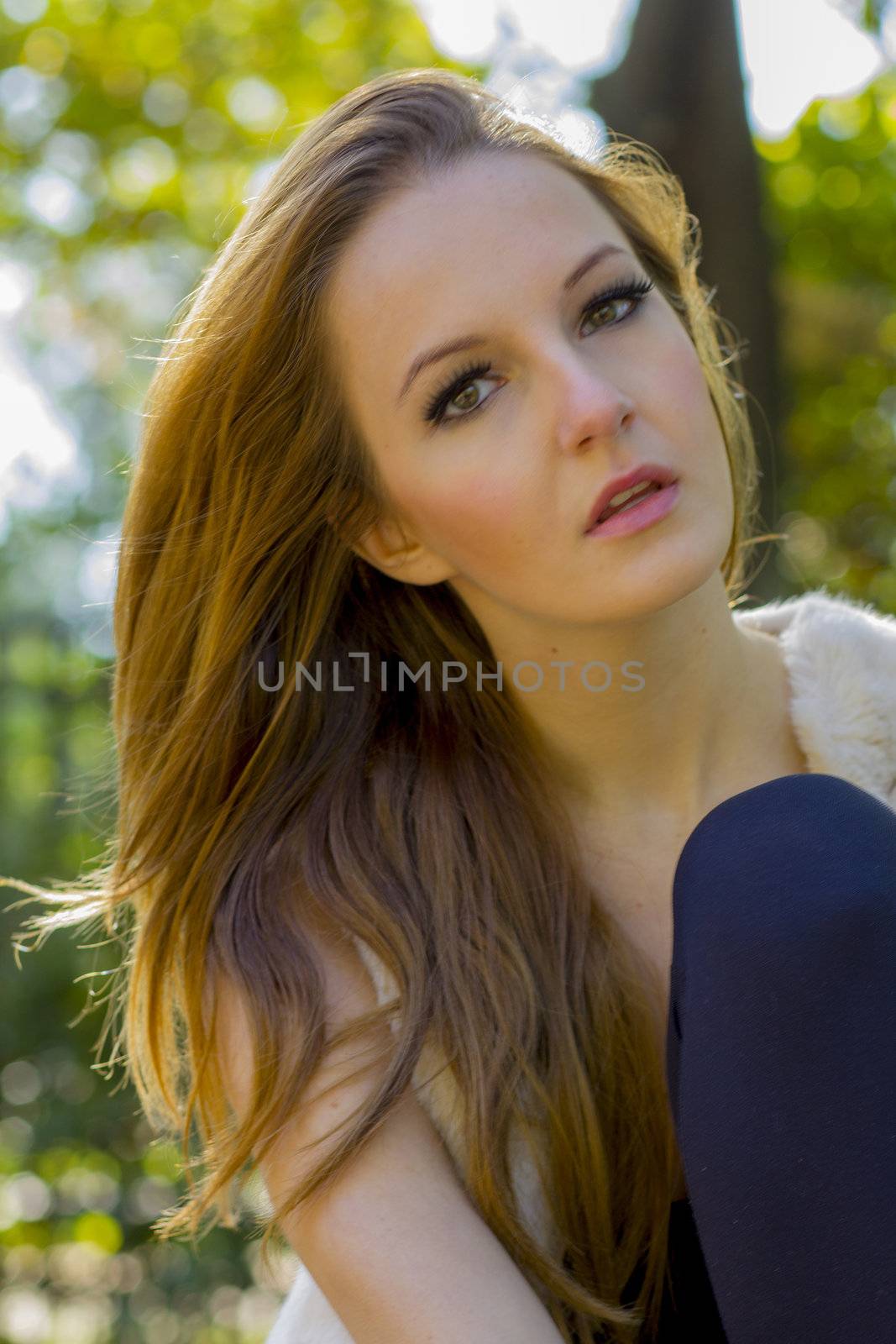 Young, beautiful woman in the city park