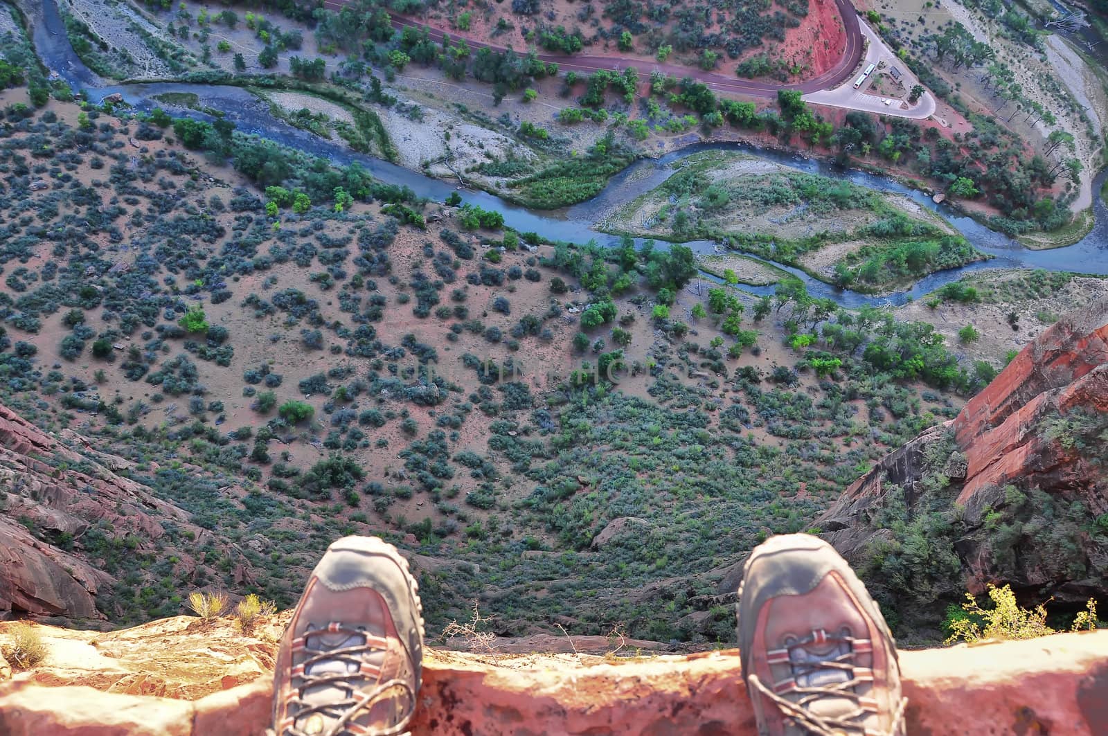Feet on the edge of rock cliff high above the ground