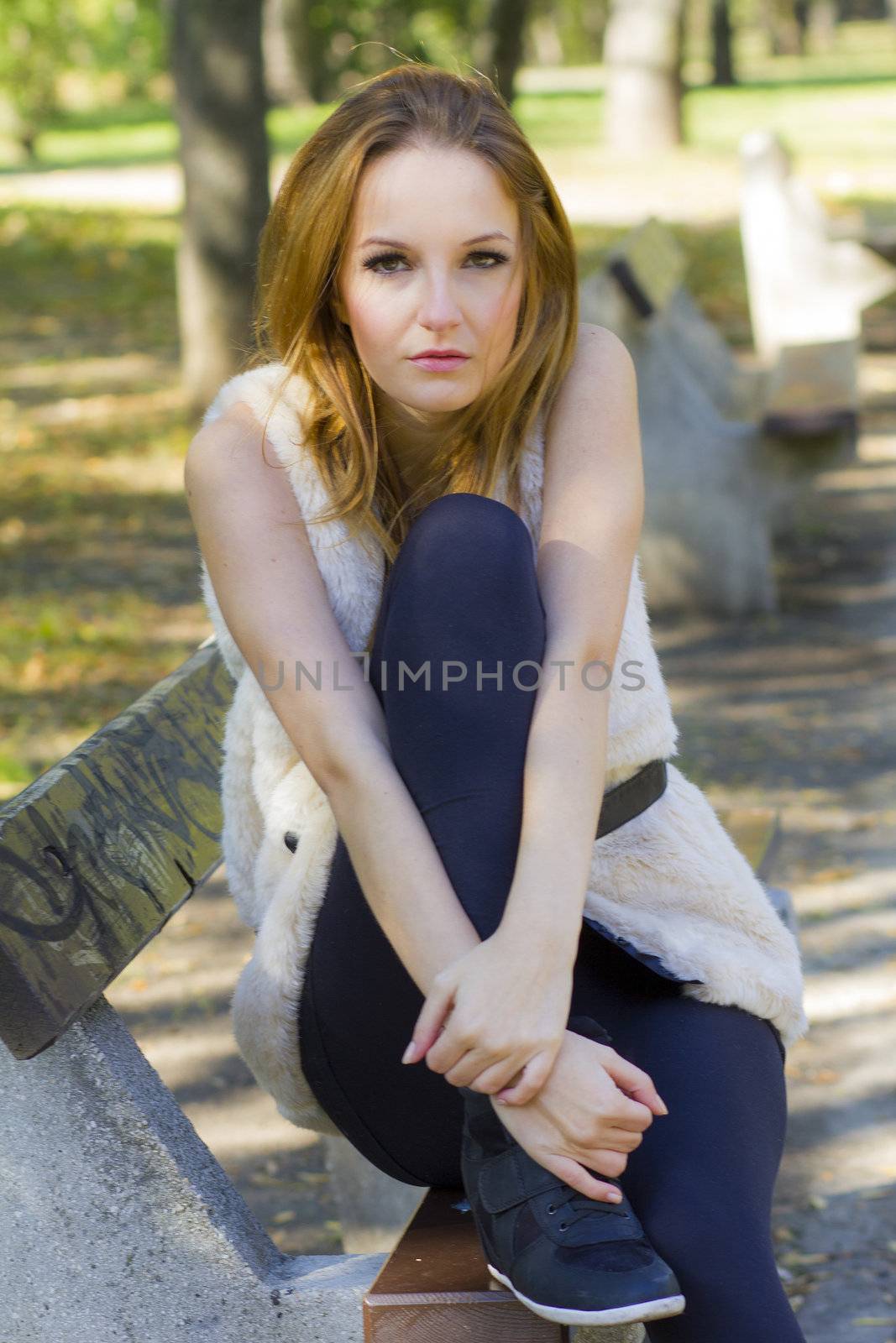 Young, beautiful woman in the city park