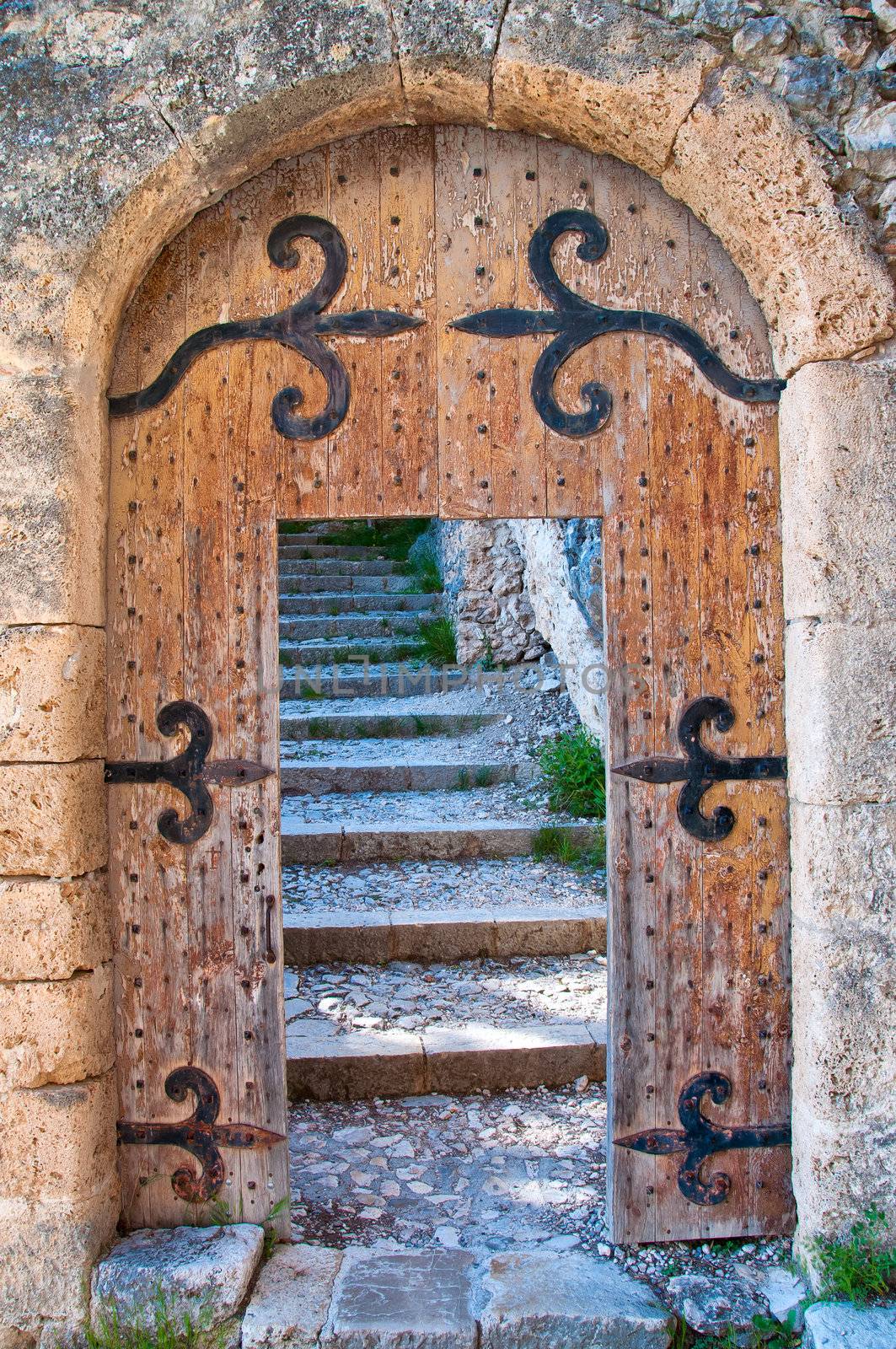 Old open wooden door with stairs by martinm303