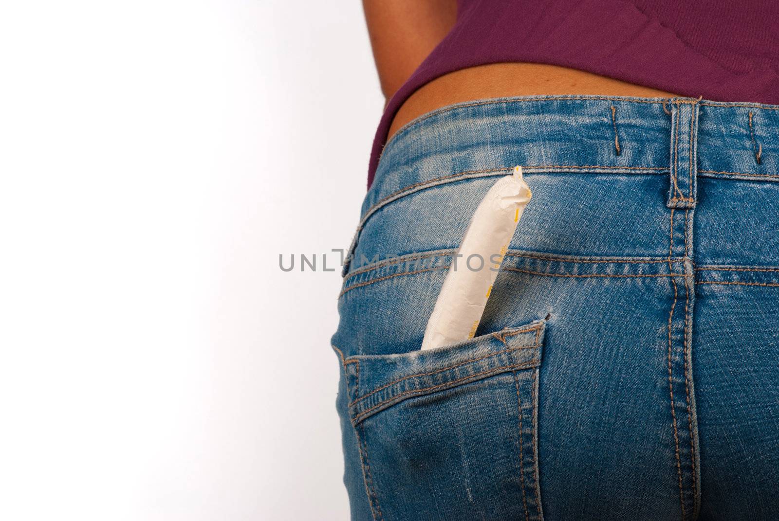 Menstruation concept: tight jeans and a tampon