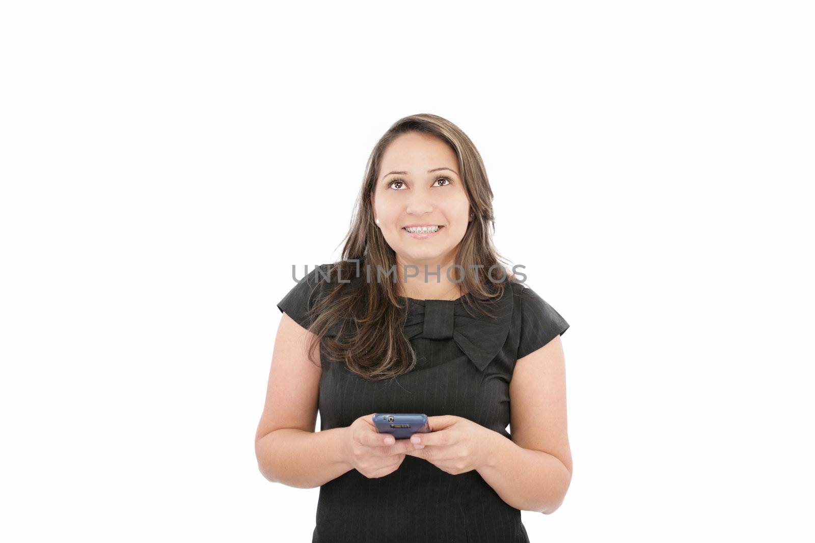 Portrait of happy young business woman text messaging on mobile phone smiling with braces