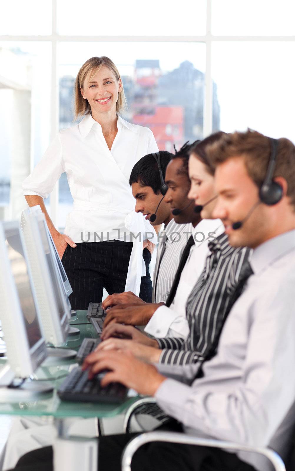 Cheerful female manager leading her representative team in a office