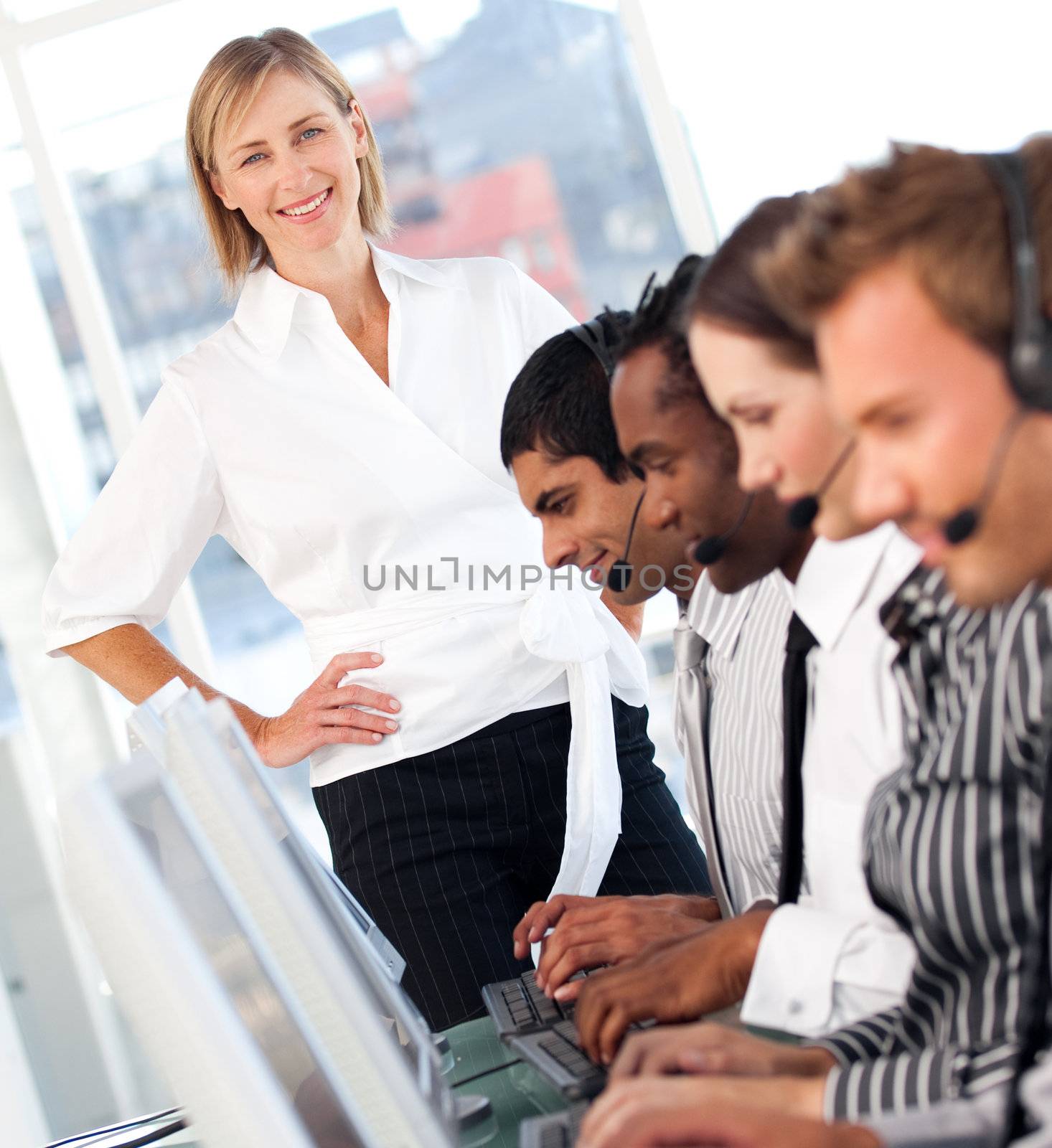 Blond female manager leading her representative team in a office