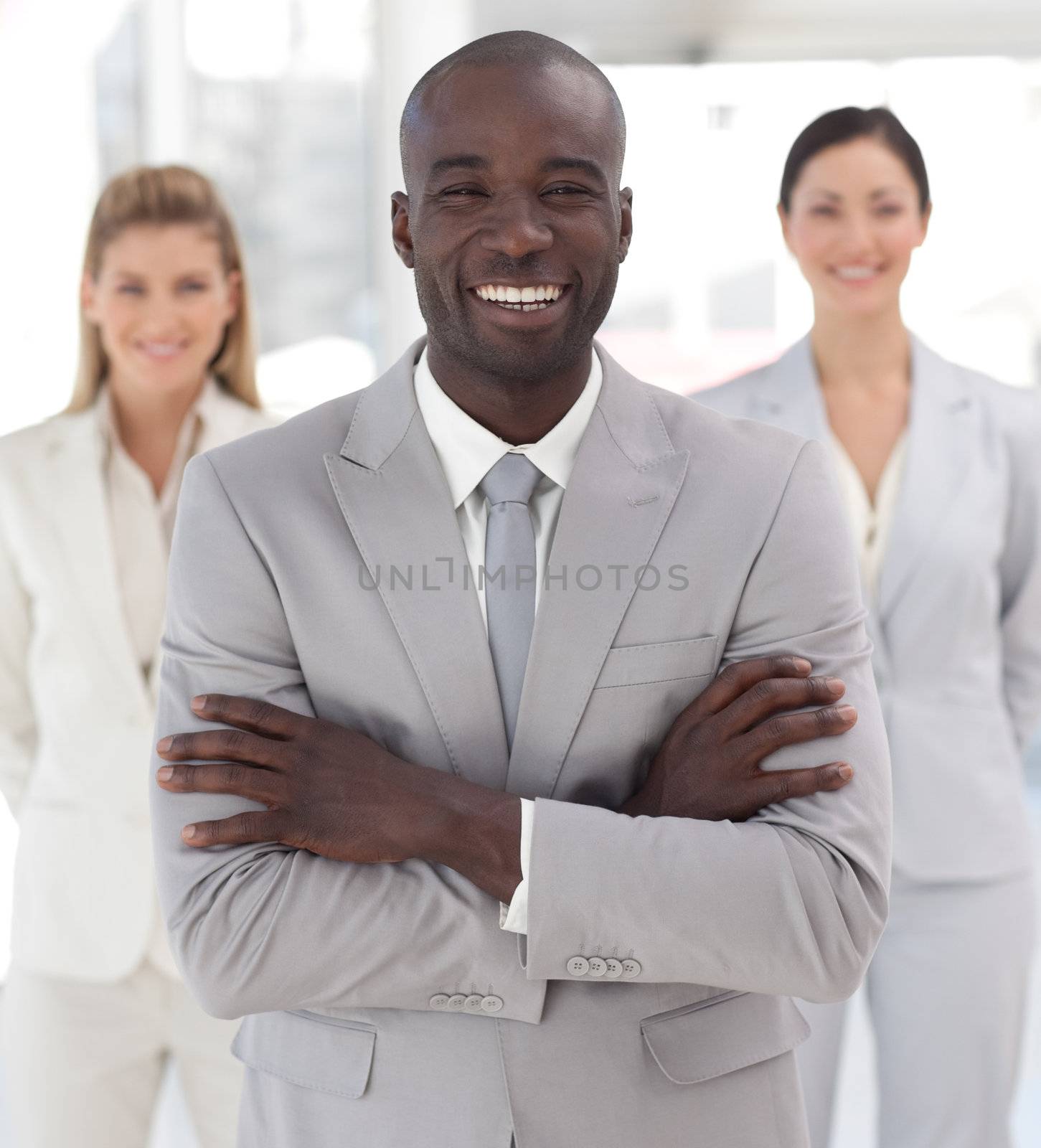 Positive afro-american manager with his team in a office