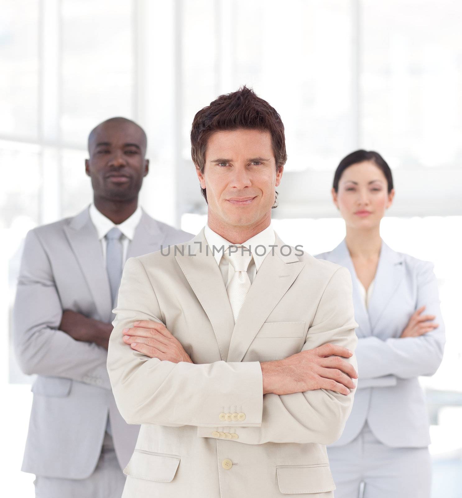 Self-assured young manager with his team in a office