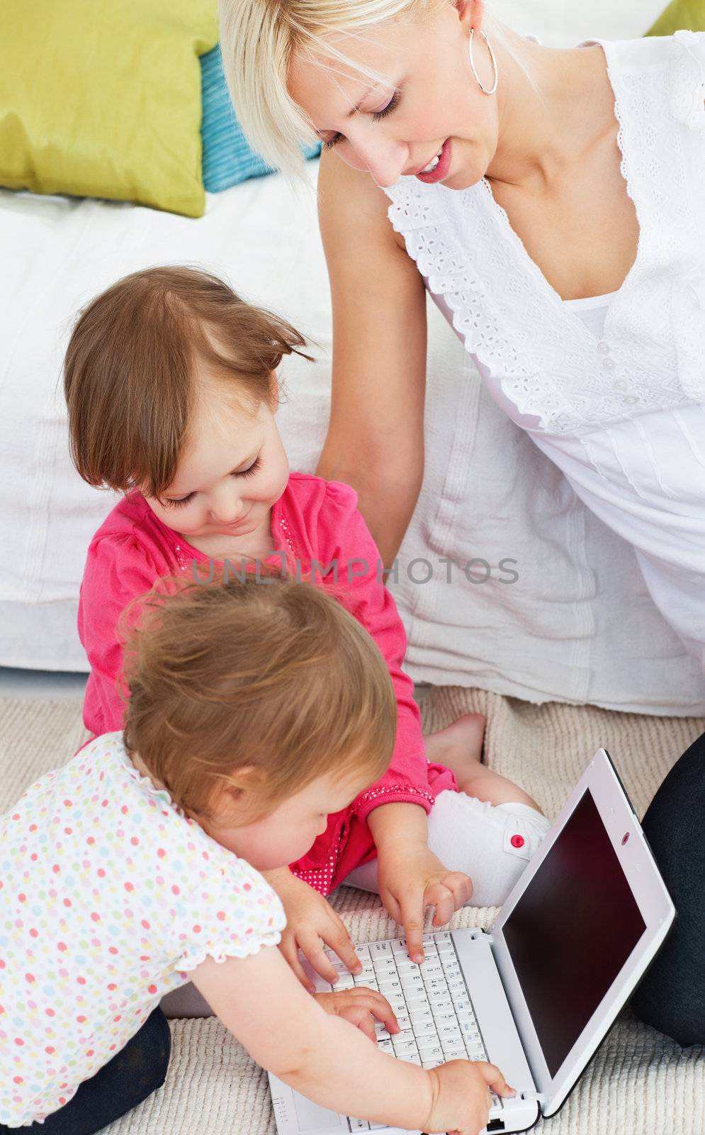 Cute family having fun with a laptop in the living-room at home