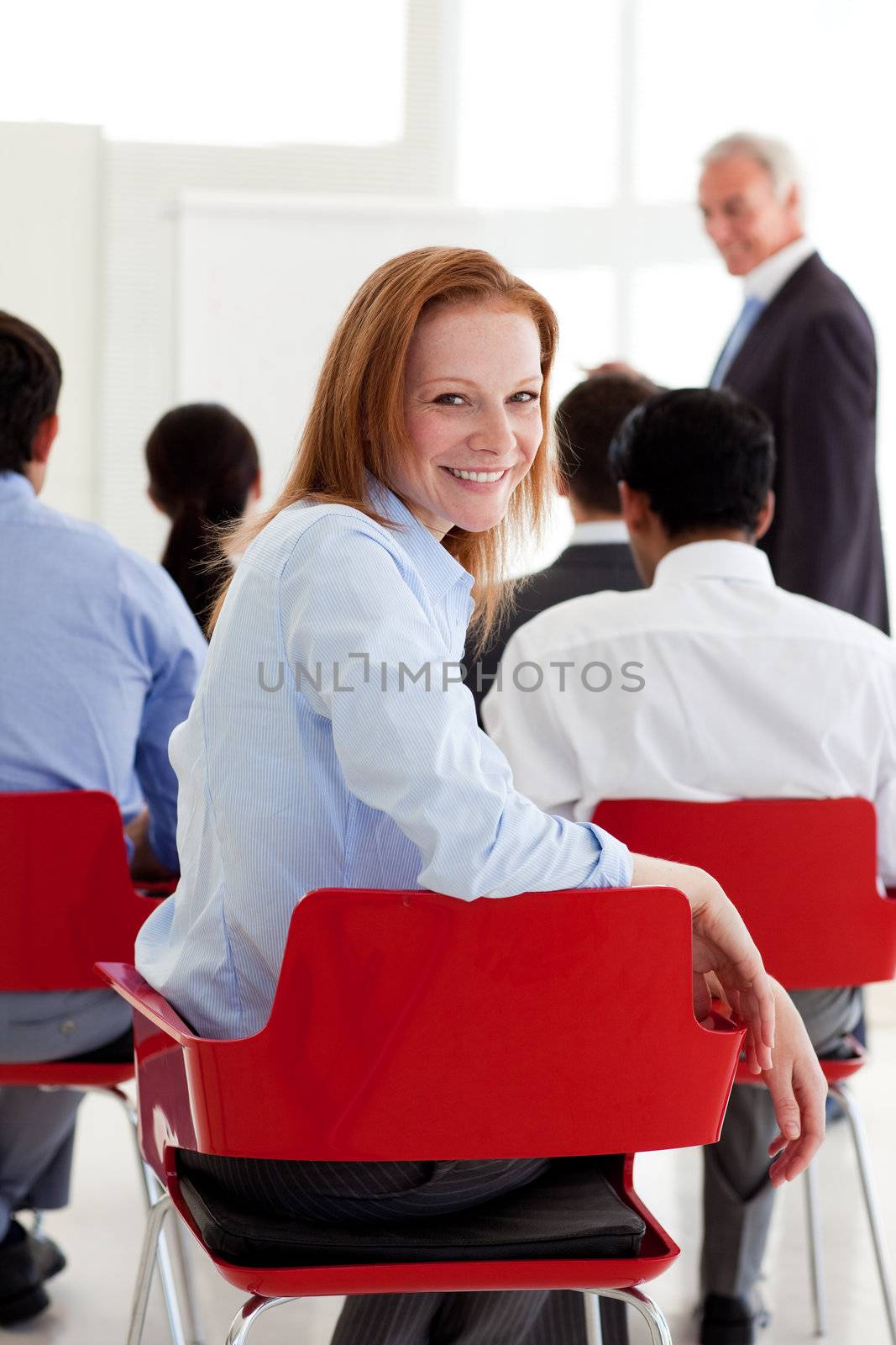 Attractive businesswoman smiling at the camera at a conference