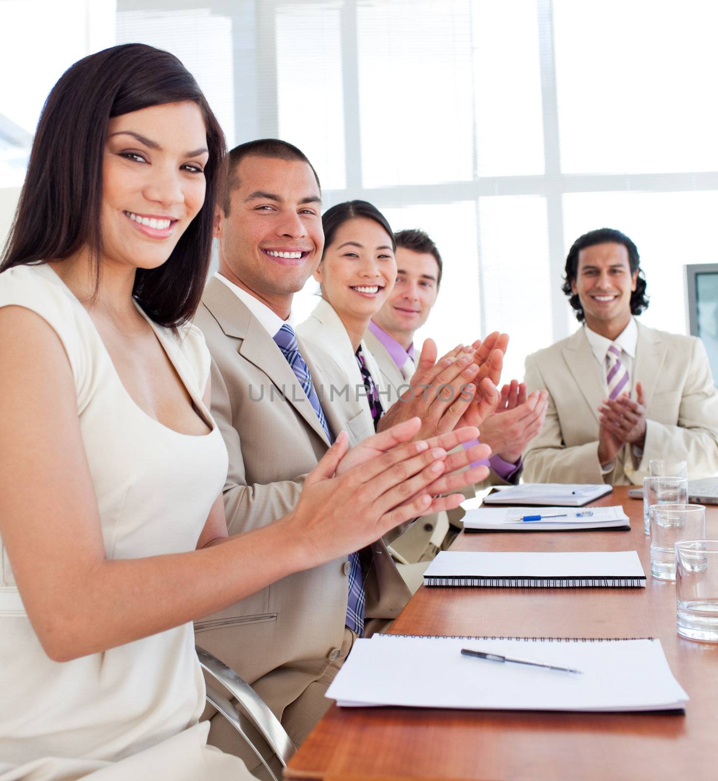 Multi-ethnic business team applauding after a conference by Wavebreakmedia