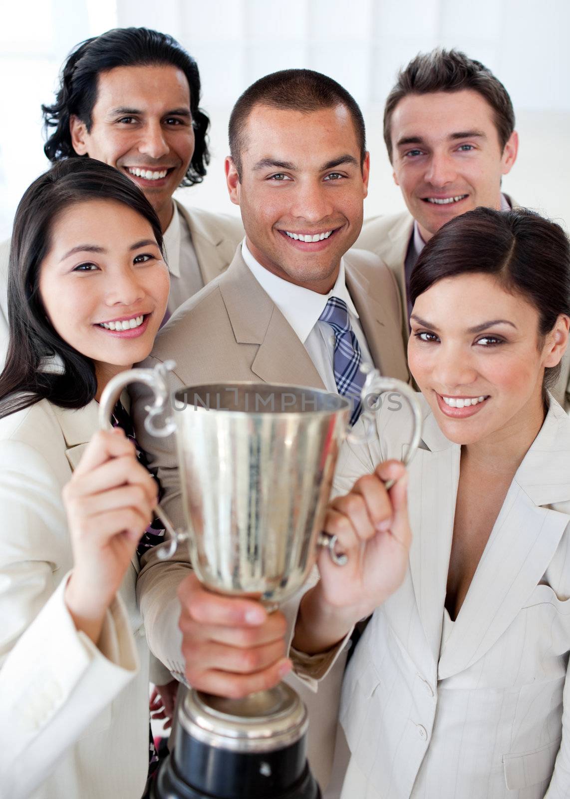 A successful business team holding a trophy by Wavebreakmedia