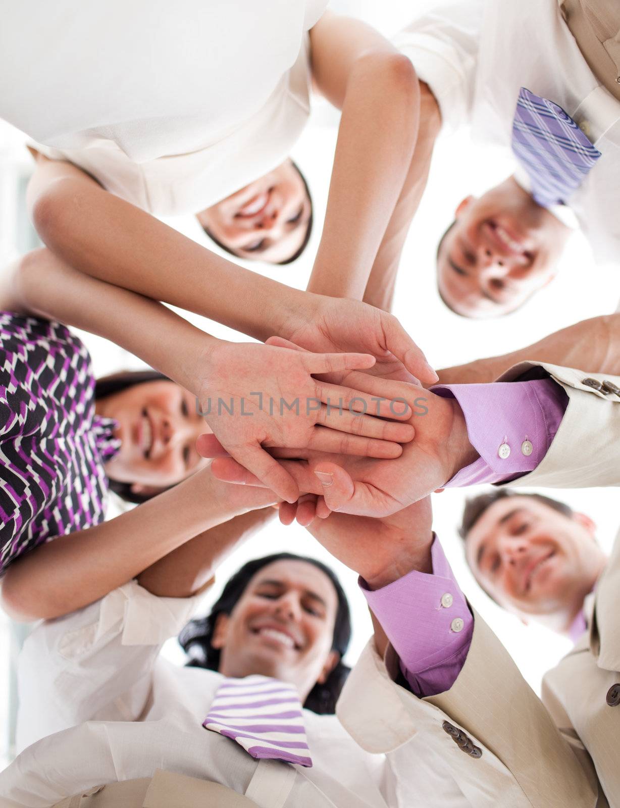 International business people holding hands together against white background
