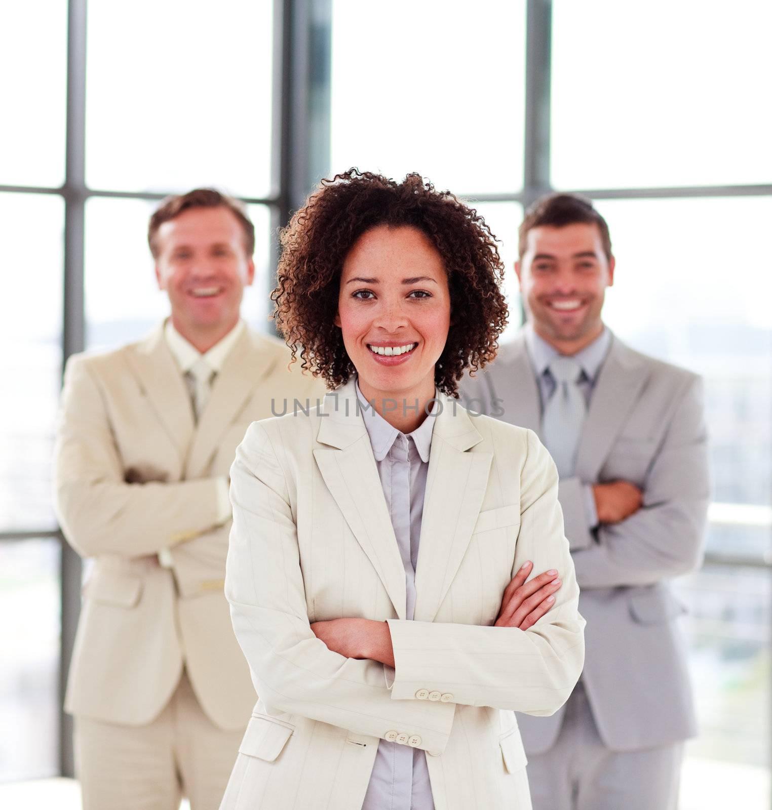 Smiling businesswoman with her team in the background by Wavebreakmedia