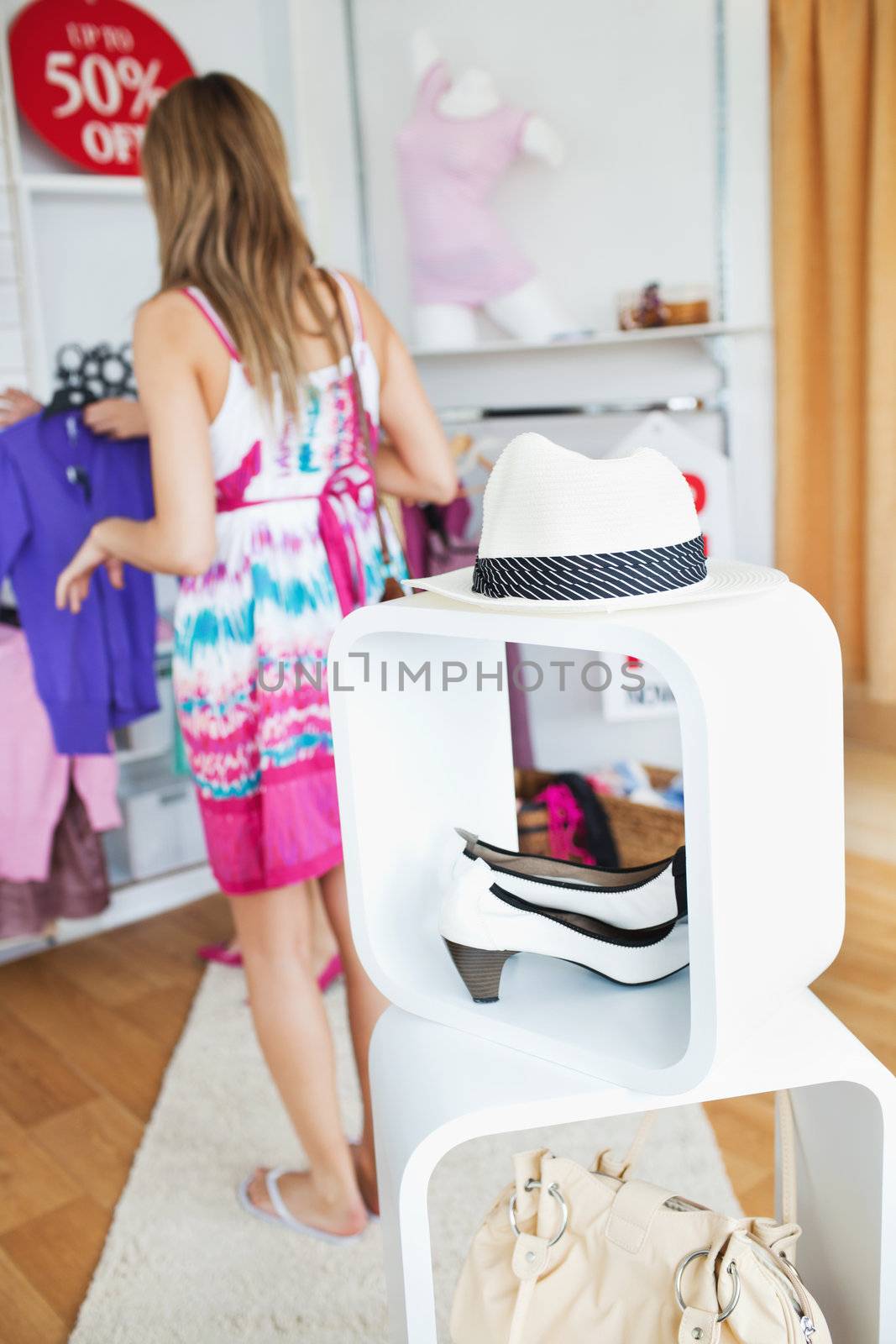 Cute woman selecting clothes  in a shop 