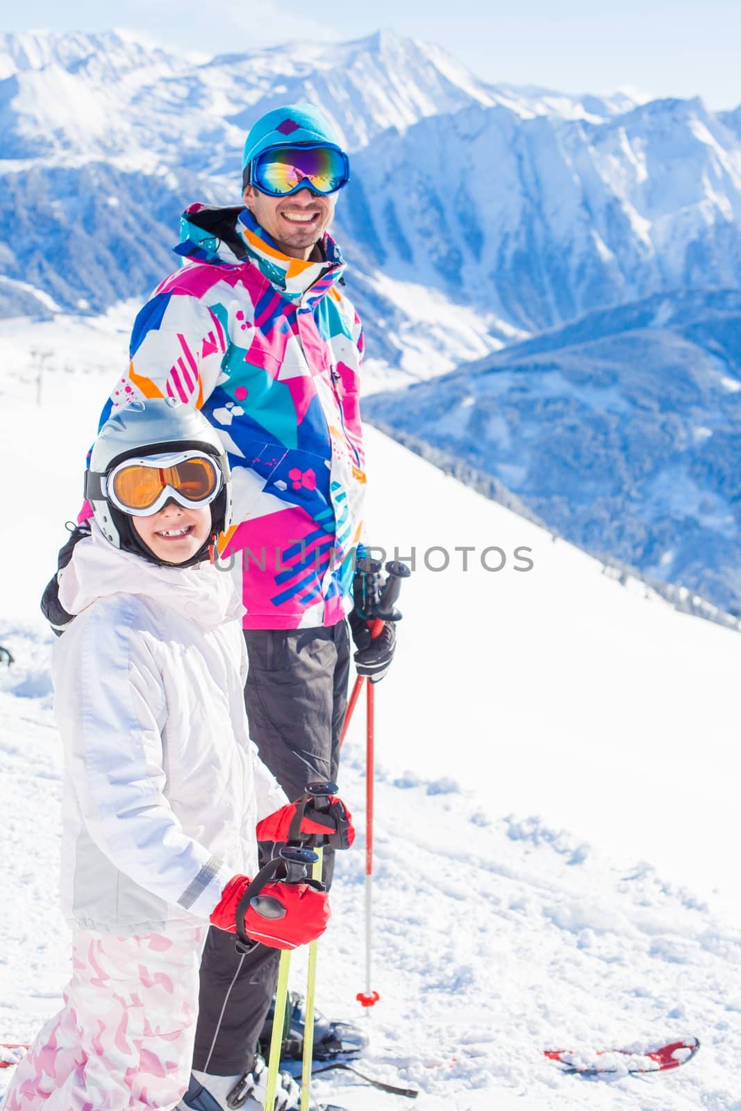 Happy smiling girl in ski goggles and with her father, Zellertal, Austria