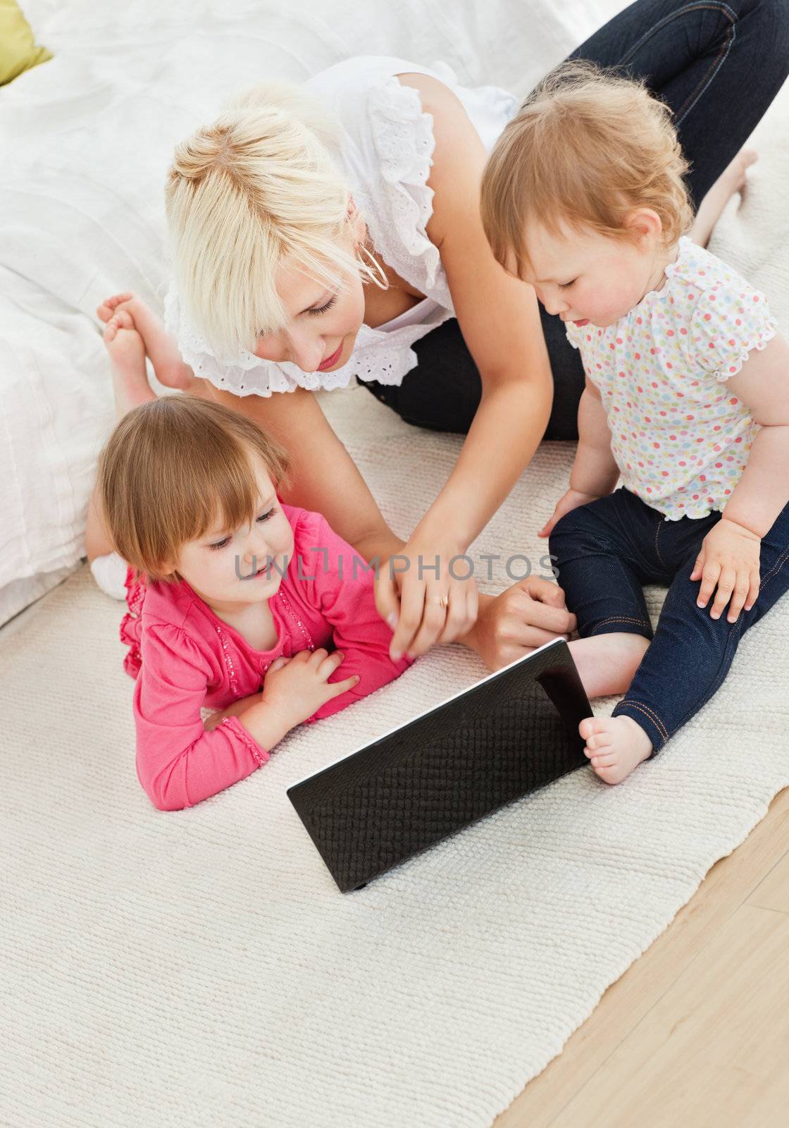 Cute family having fun with a laptop in the living-room at home 
