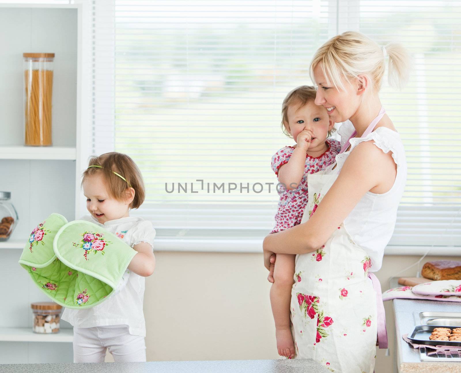 Mother having fun with her daughters in living room