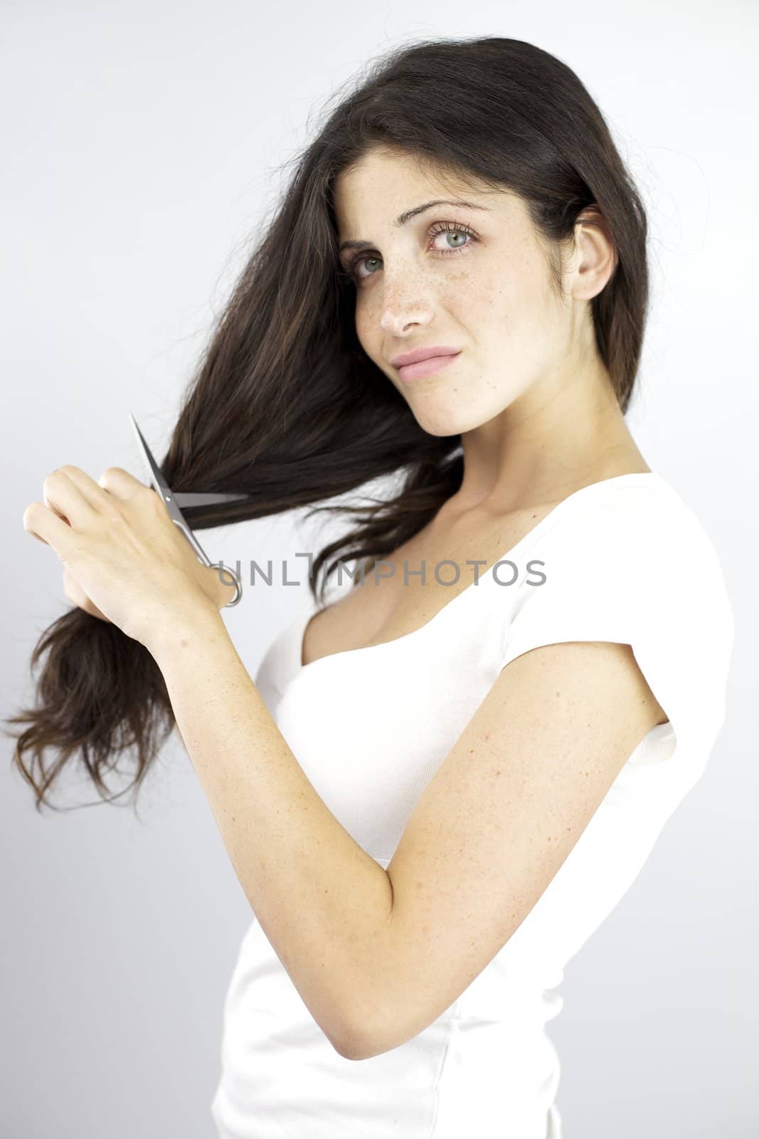 Young woman sad of cutting her hair with scissors
