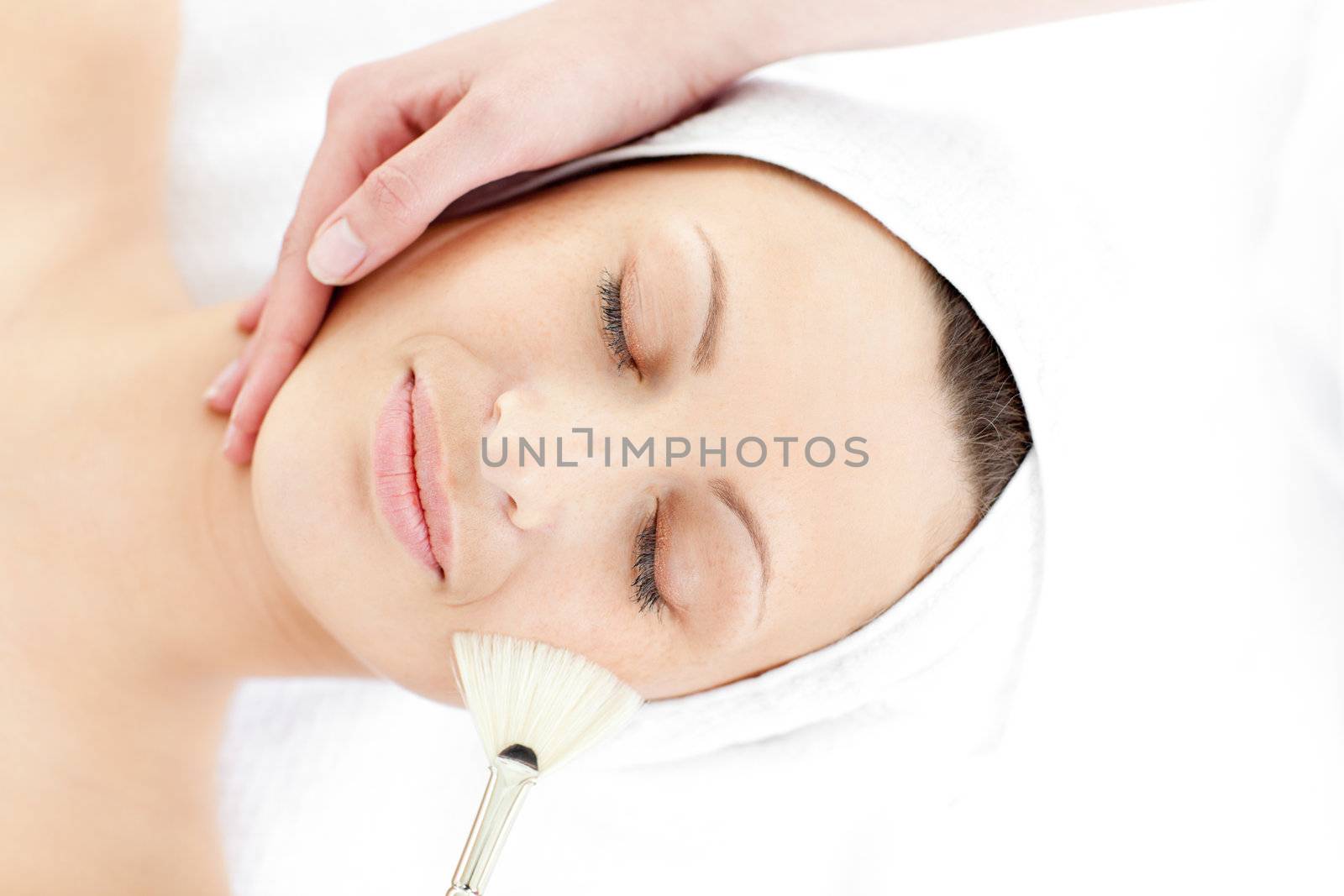 Cute young woman enjoying a beauty treatment in a spa center