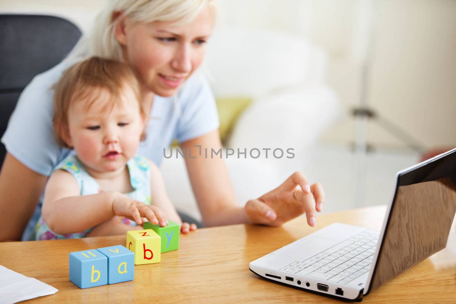 Positive family using laptop and playing with toys in the living-room