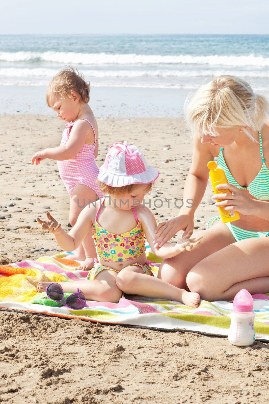 Positive caucasian family at the beach in the sun