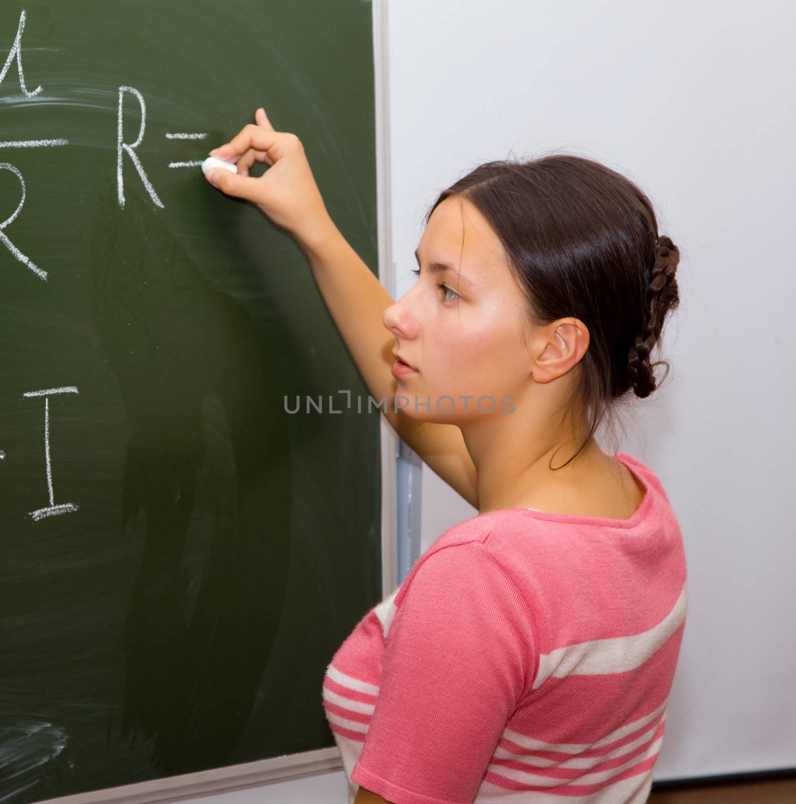A pretty girl in a physics class wrote on the blackboard formula