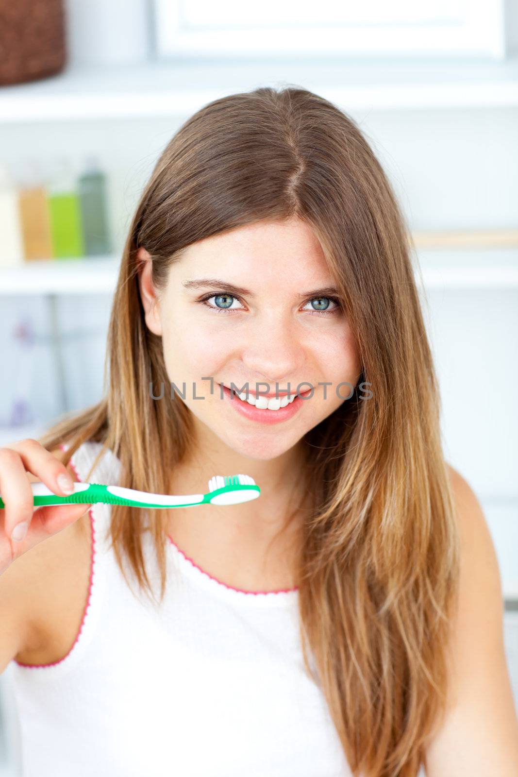 Captivating caucasian woman holding a toothbrush in the bathroom