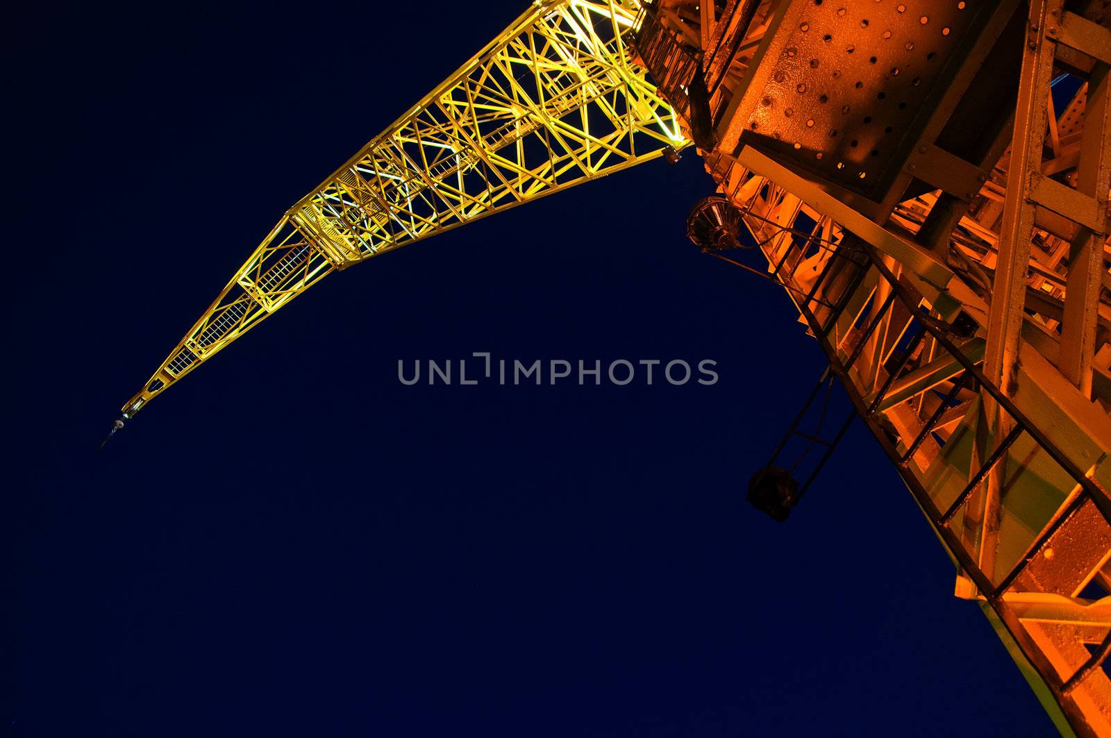 A yellow and orange crane at night in Buenos Aires.