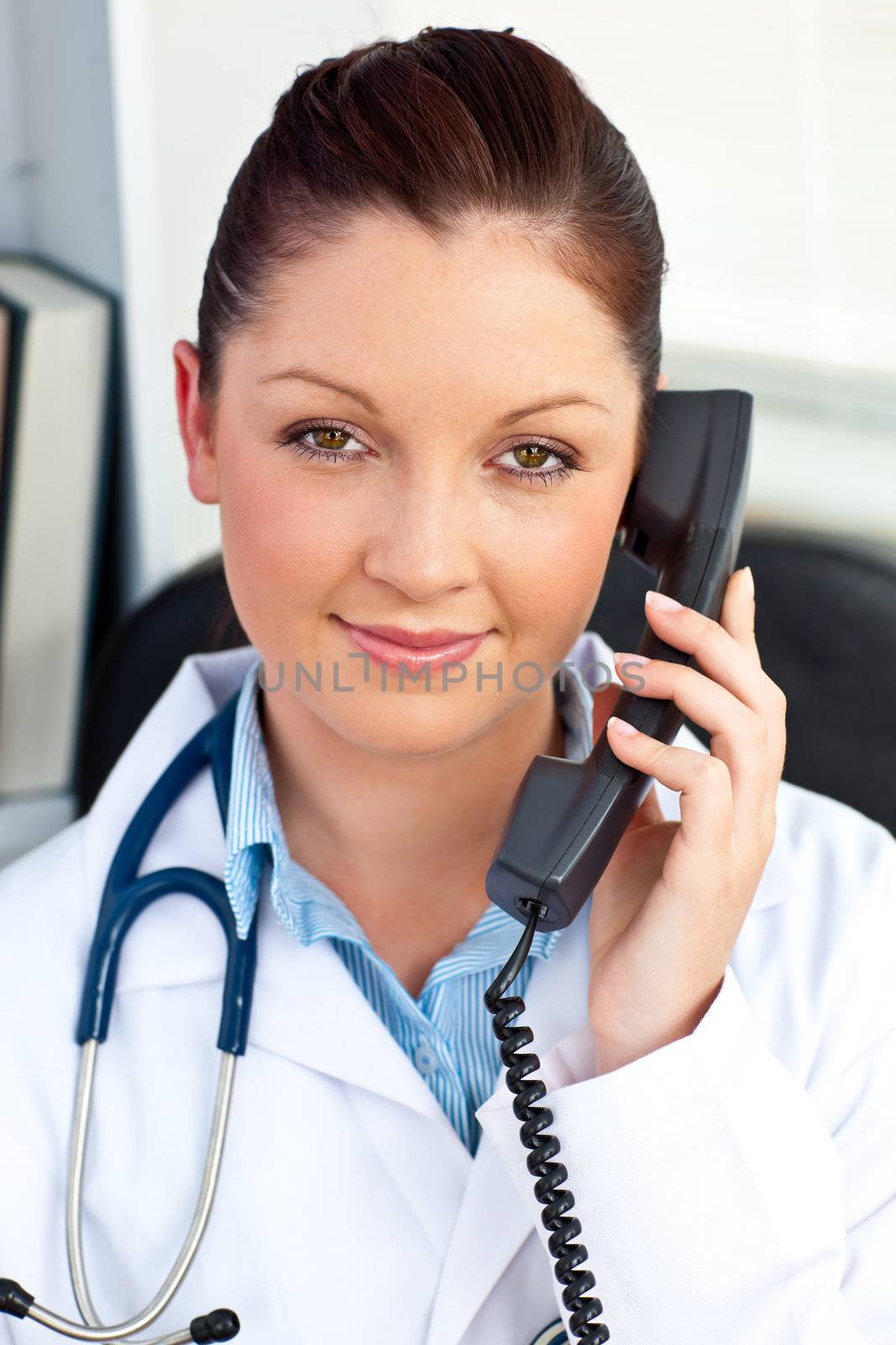 Portrait of an assertive female doctor phoning in her office by Wavebreakmedia