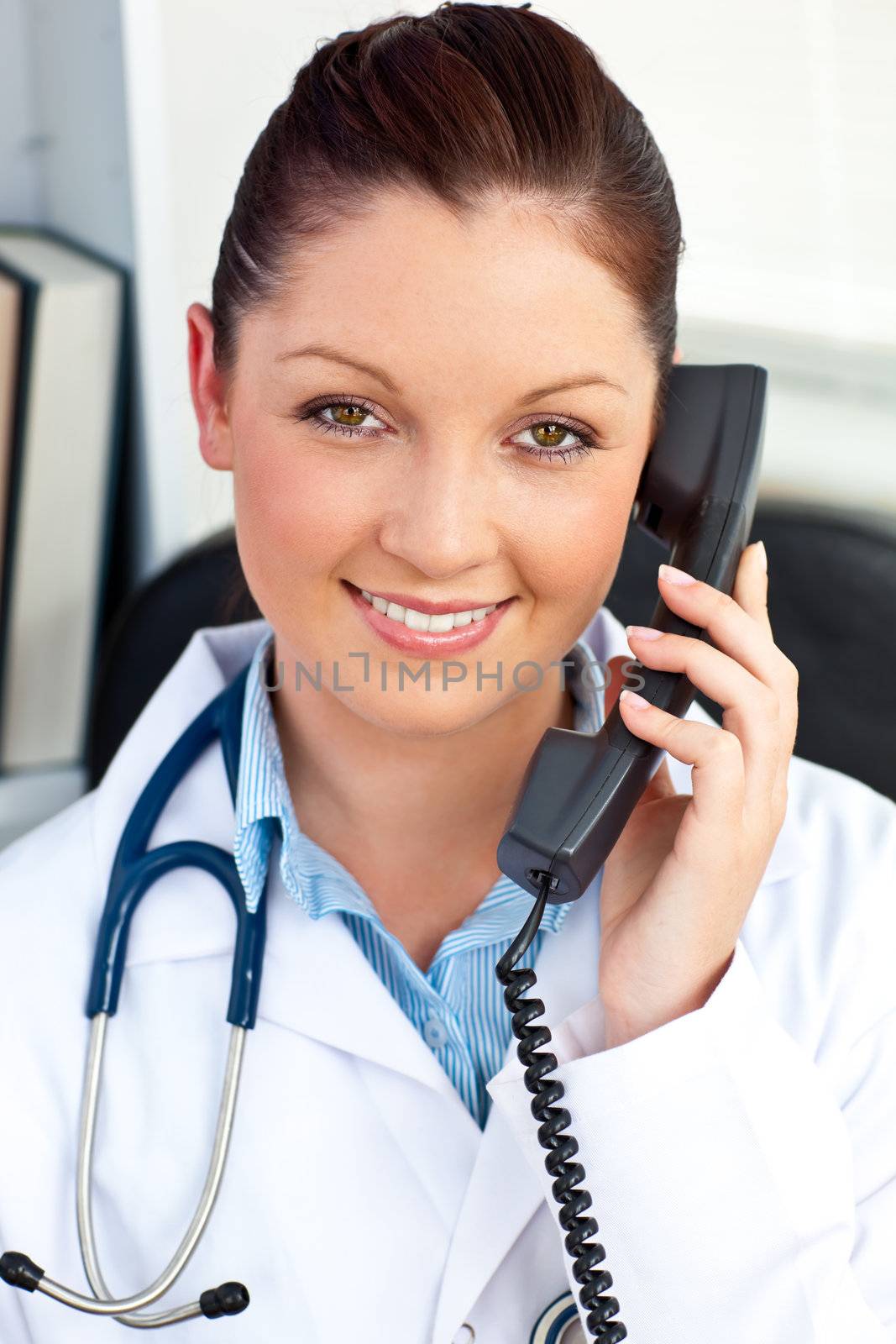 Smiling female doctor talking on phone by Wavebreakmedia